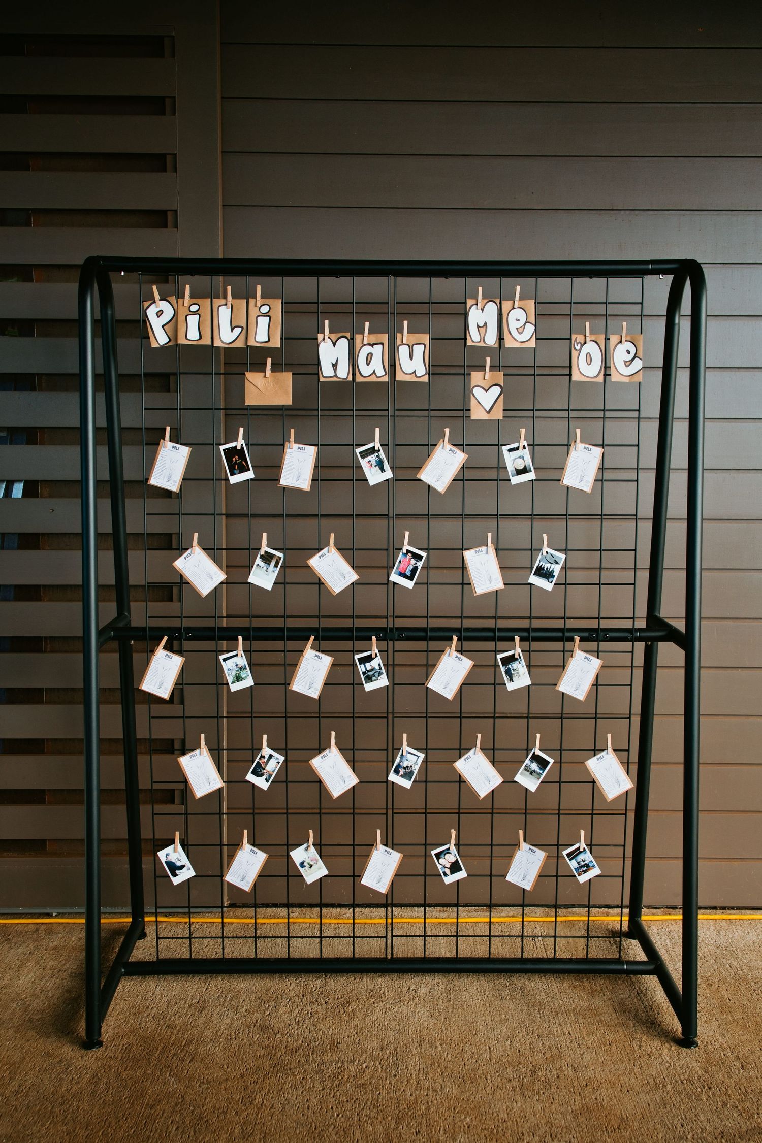 Photographs and cards clipped to a black metal display at the reception.