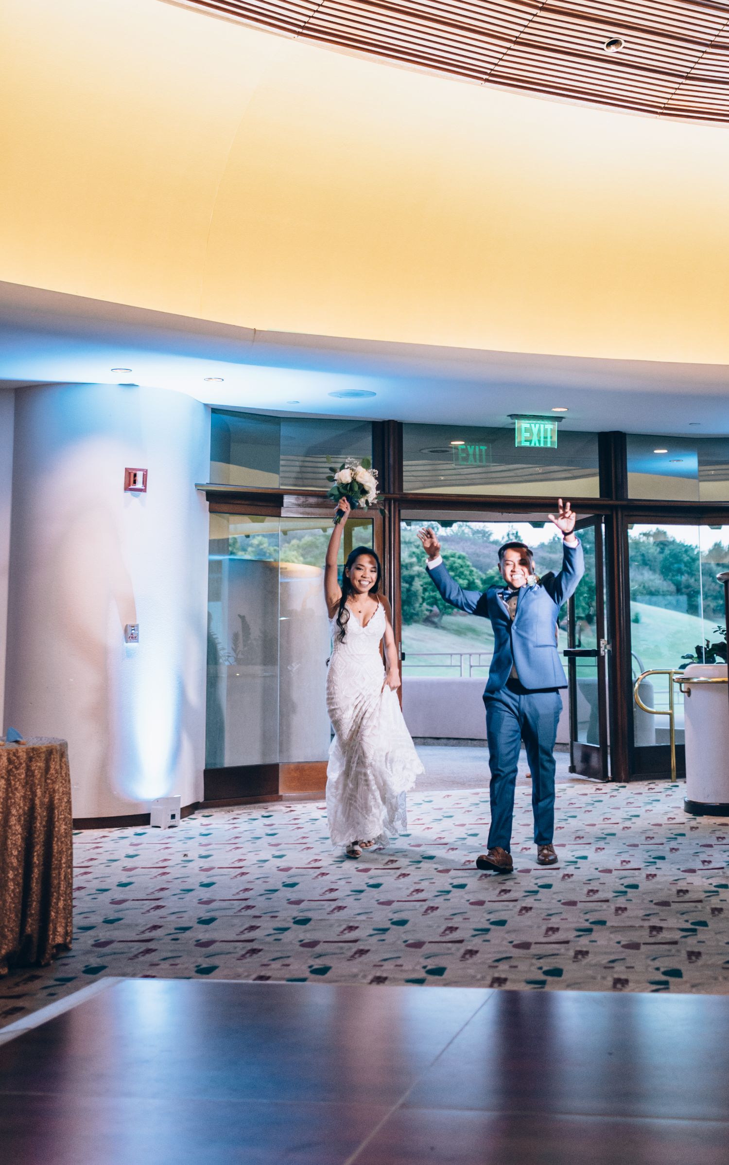 Wedding celebration features synchronized dance moves in a modern venue with floor-to-ceiling windows.