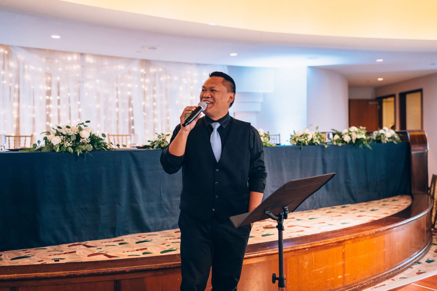 Wedding entertainment performers on stage during reception celebration.