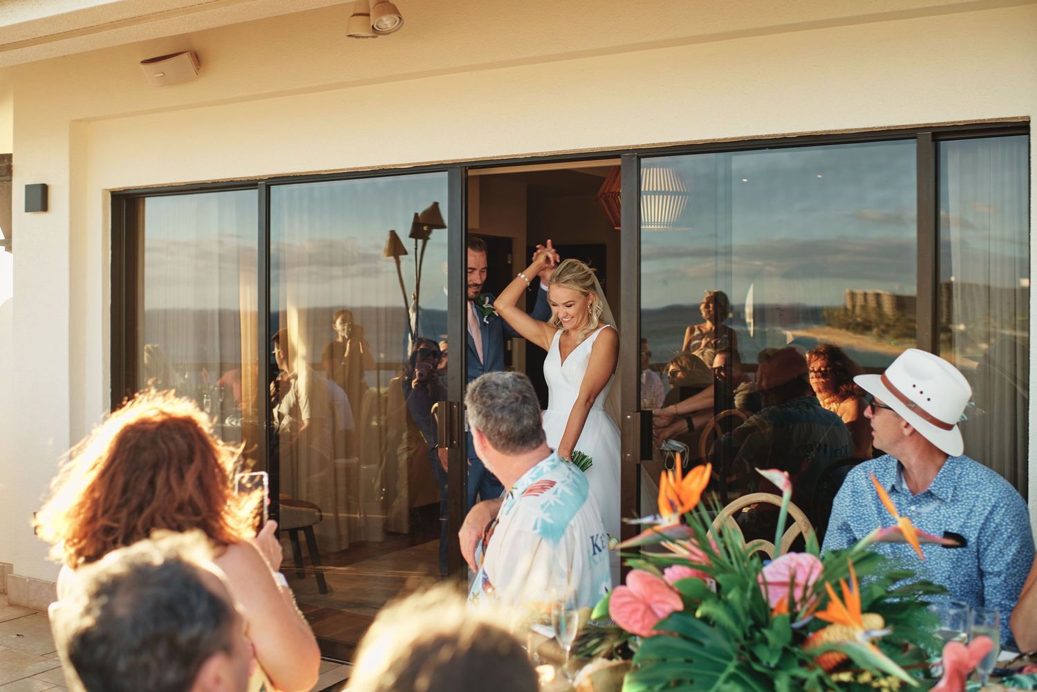 Wedding reception celebration with guests dancing on outdoor patio.