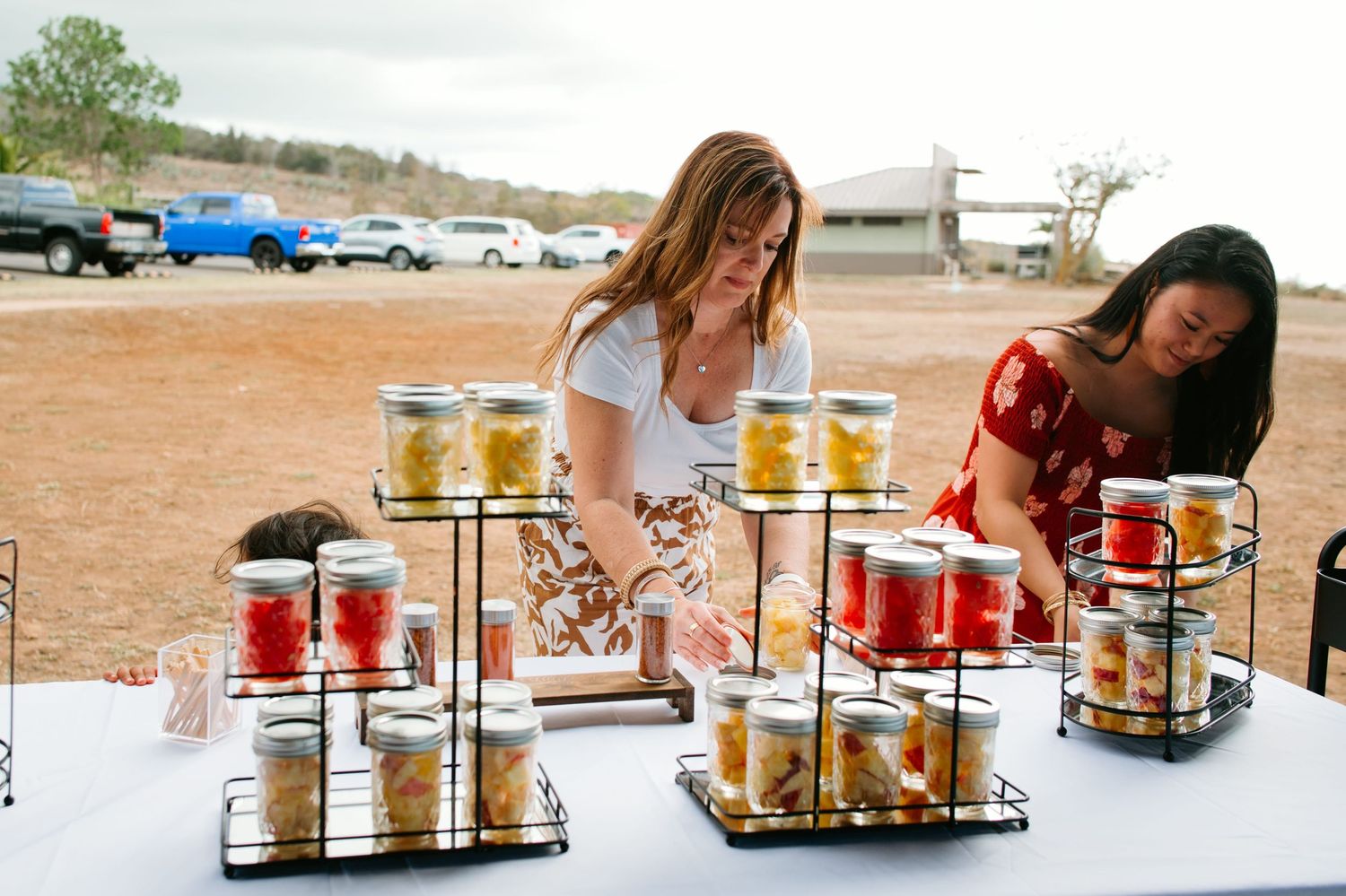 Guests arrange drinks at the outdoor wedding reception.