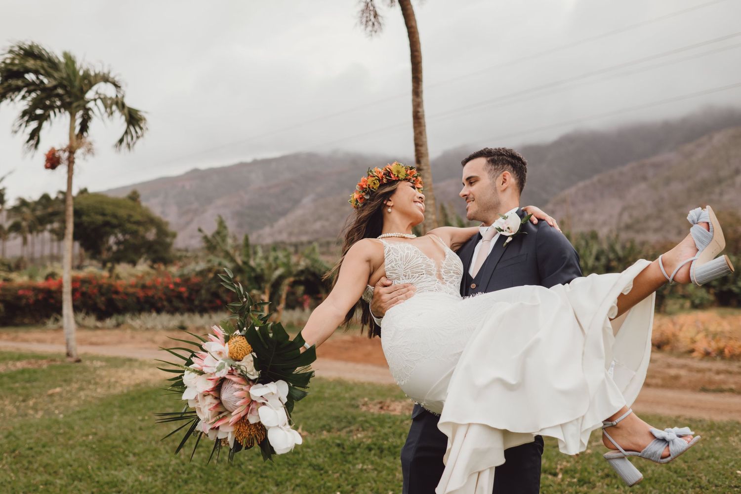 Elegant wedding photography session with mountain backdrop and palm trees.
