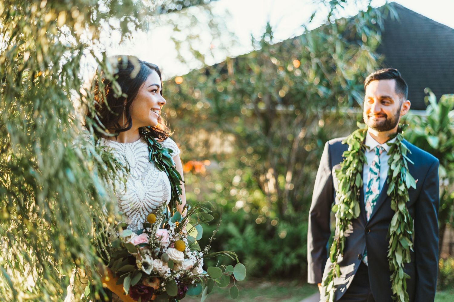bride and groom looking at each other for bridal portraits at the hui no'eau during golden hour