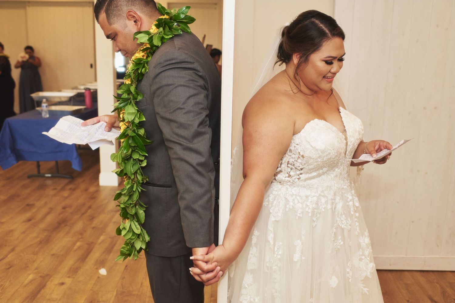 A tender moment shared between a couple during their wedding ceremony in an elegant indoor setting.