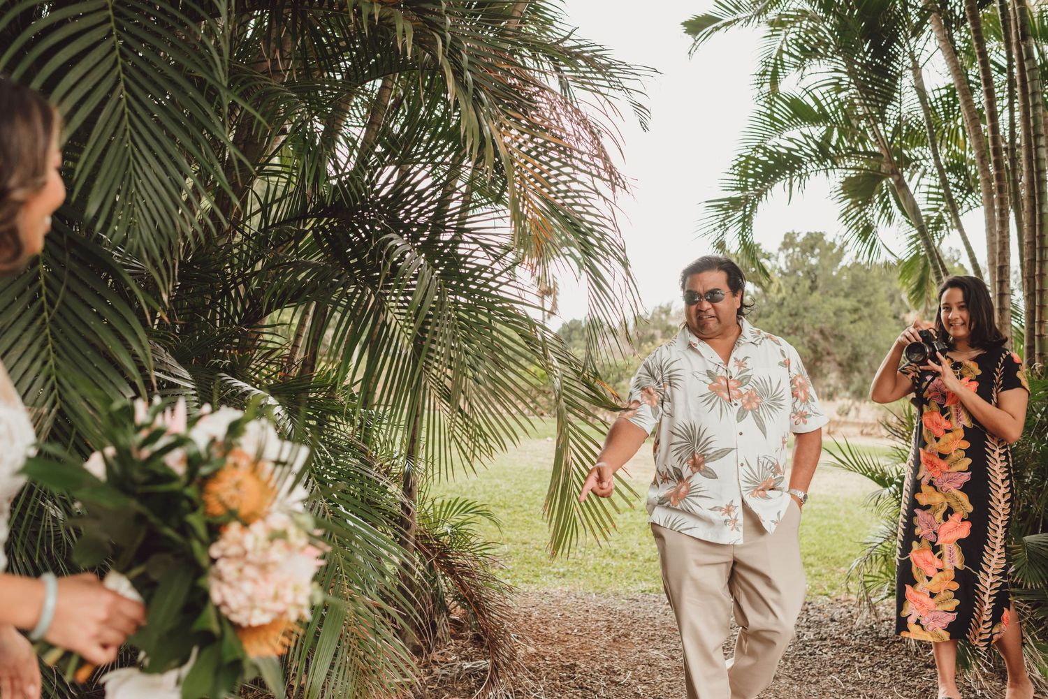 Tropical garden wedding setting with palm trees and natural landscaping creating a romantic atmosphere.