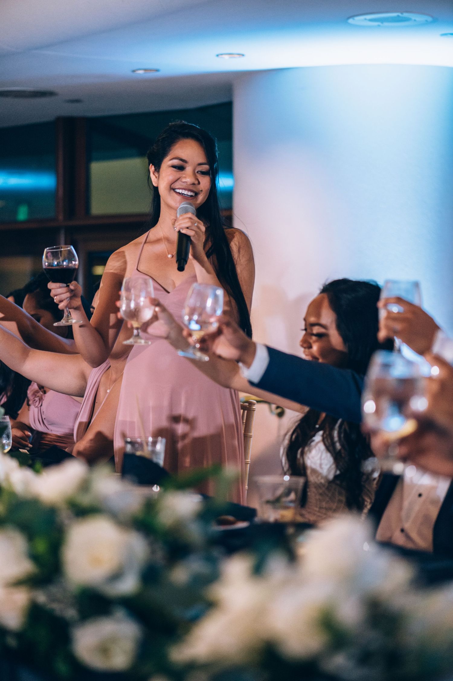Wedding guests enjoy drinks and celebrations at an elegant reception dinner.
