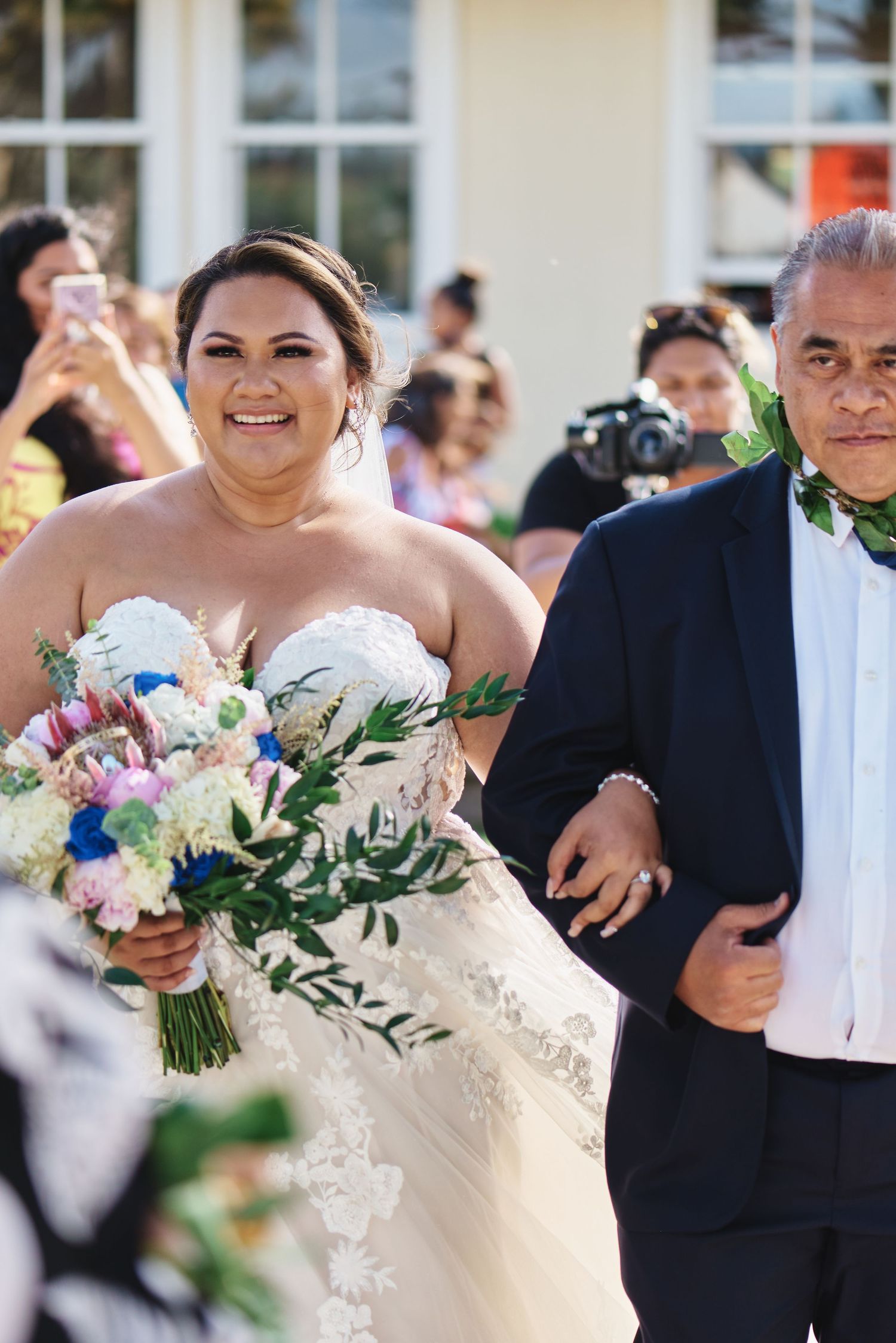 Wedding party holds colorful bouquets during outdoor celebration.