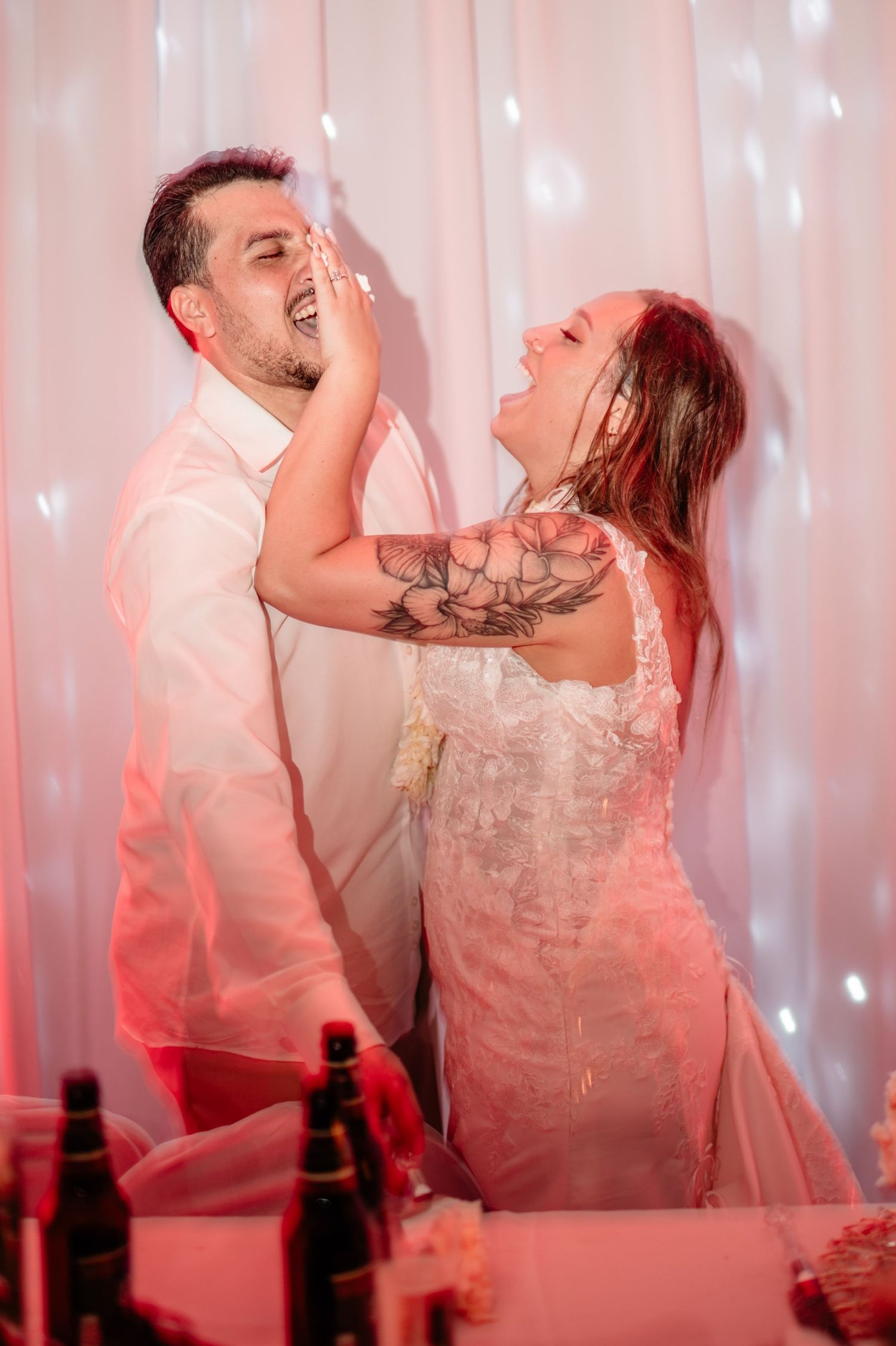 Newlyweds sharing a playful moment during their wedding reception.
