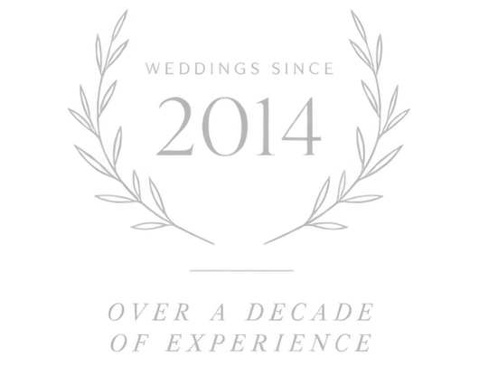 Elegant laurel wreath emblem for weddings since 2014, over a decade of experience.