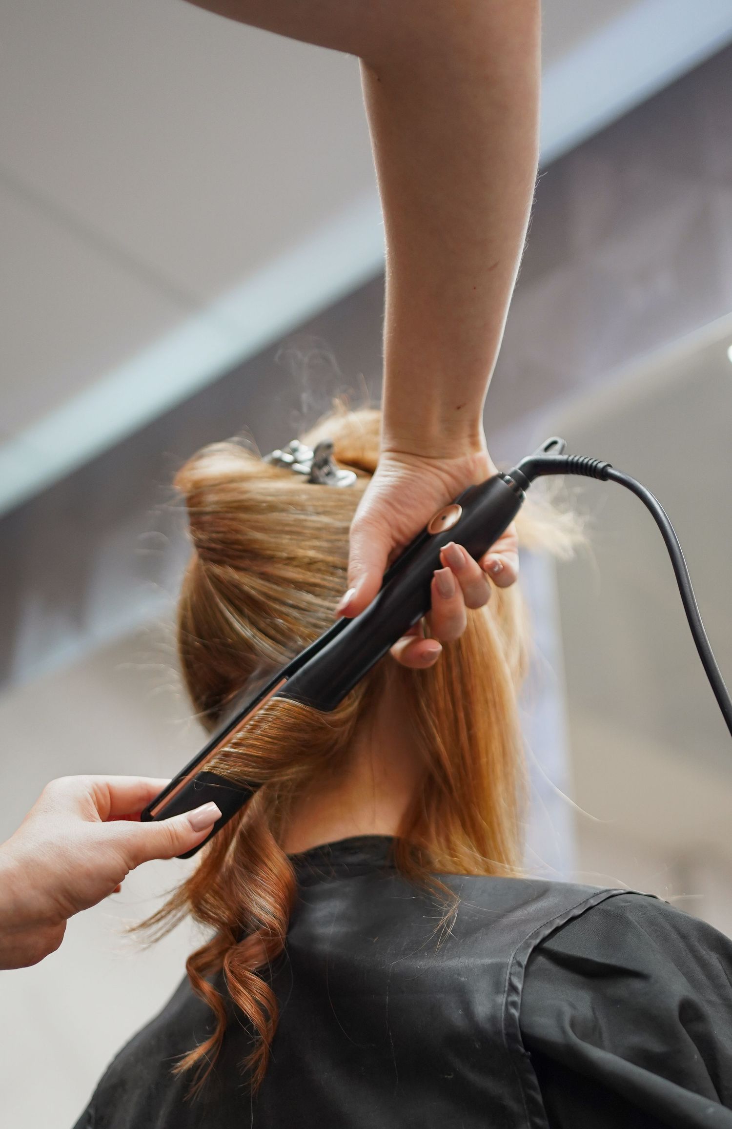 Hairdresser blow-drying client's hair, commercial photography for hair salons in the Netherlands
