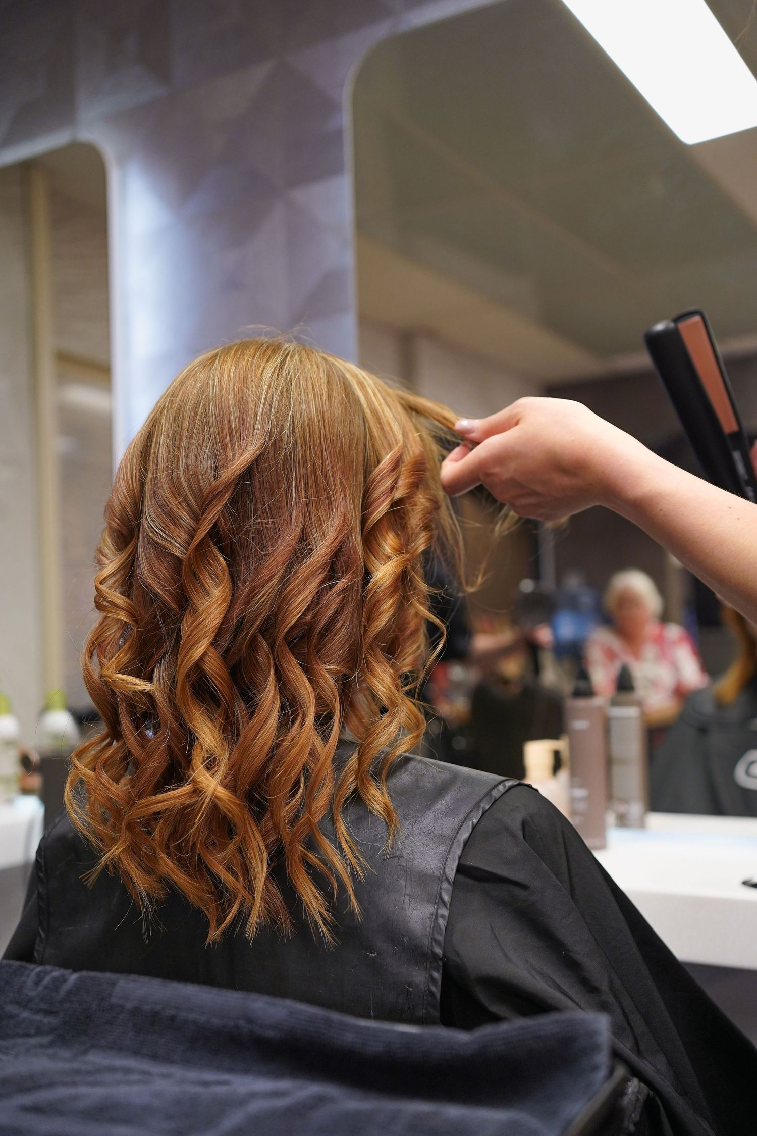 Hairdresser blow-drying client's hair, commercial photography for hair salons in the Netherlands