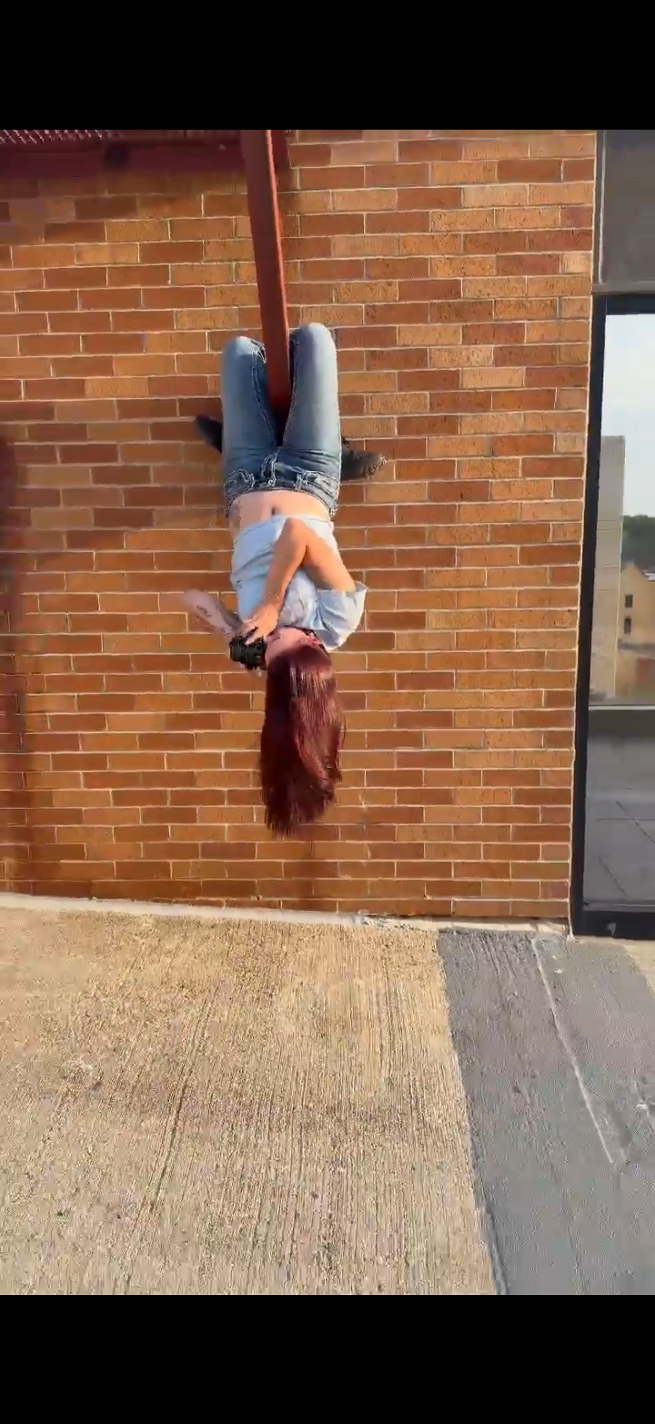 Photographer hanging upside down to capture a photo