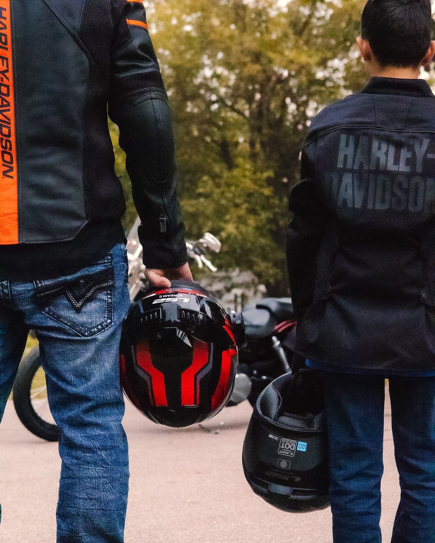 Father and son with motorcycle and gear during an outdoor photography session