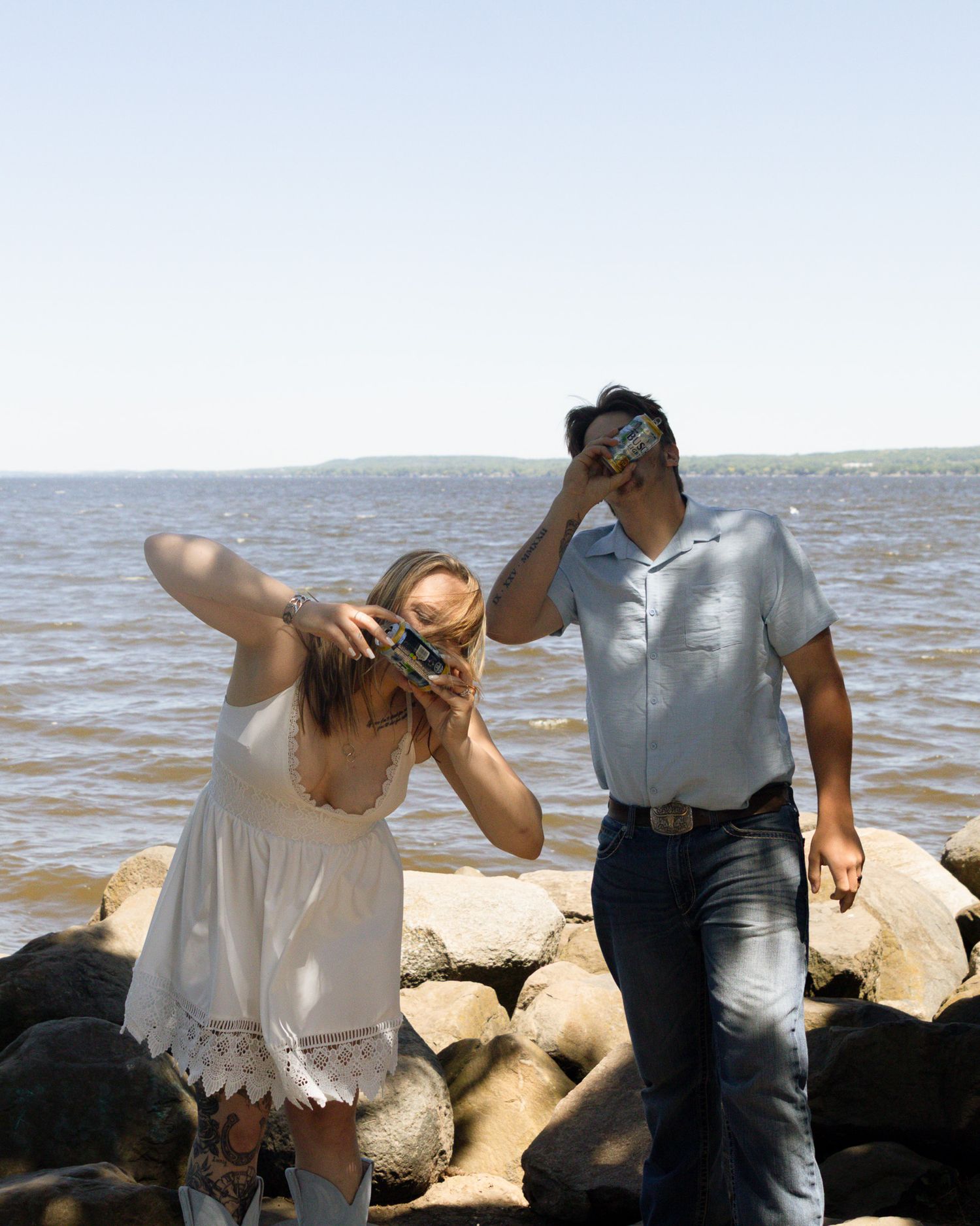 Couple celebrating with drinks during a photography session