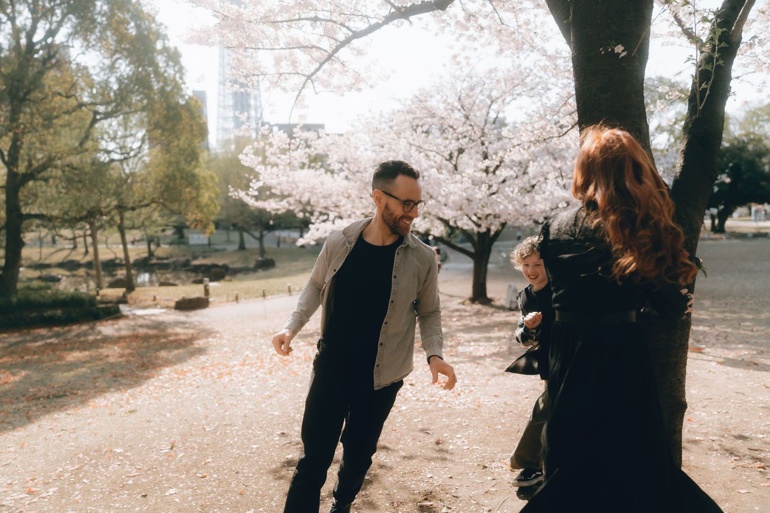 Couple dancing together in sumida park with blooming cherry blossom trees during spring.