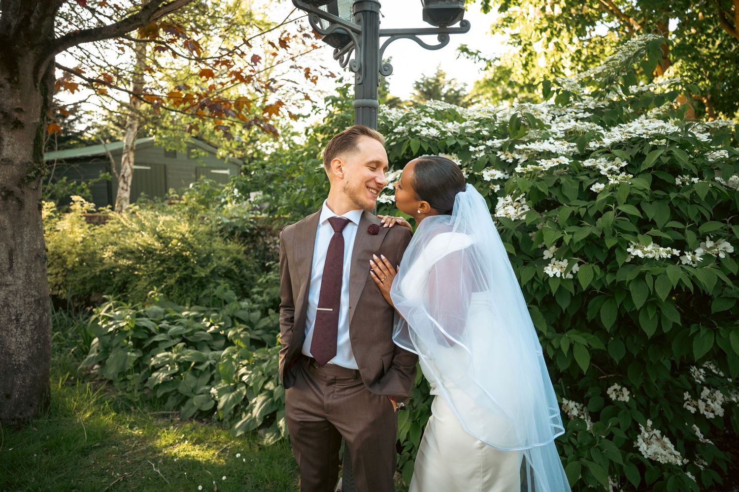 Portrait photo of the wedding couple looking at each other, it is sharp with high contrast and a blurry background.