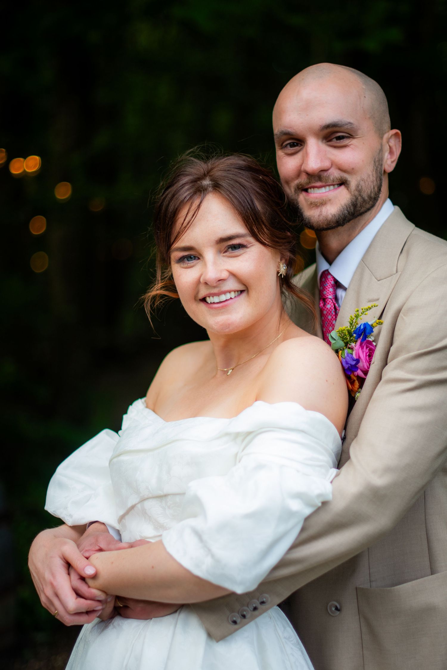 Portrait photo of the wedding couple posing, it is sharp with high contrast and a blurry background.