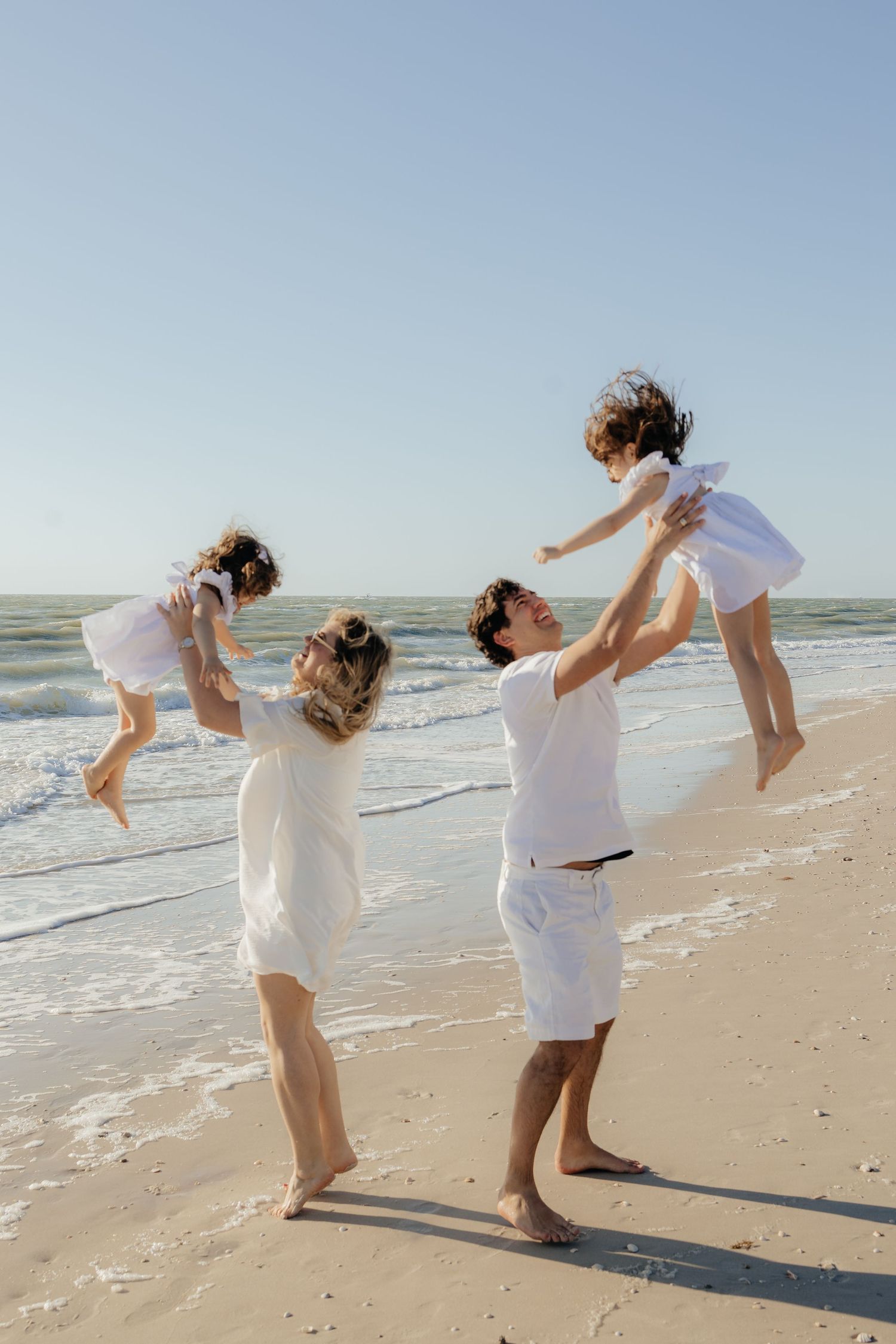 daughters and parents throwing in the air