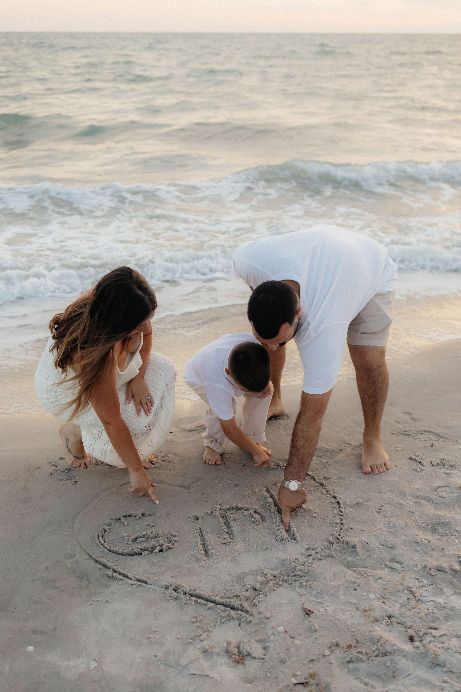 including son in gender reveal at the beach in Florida