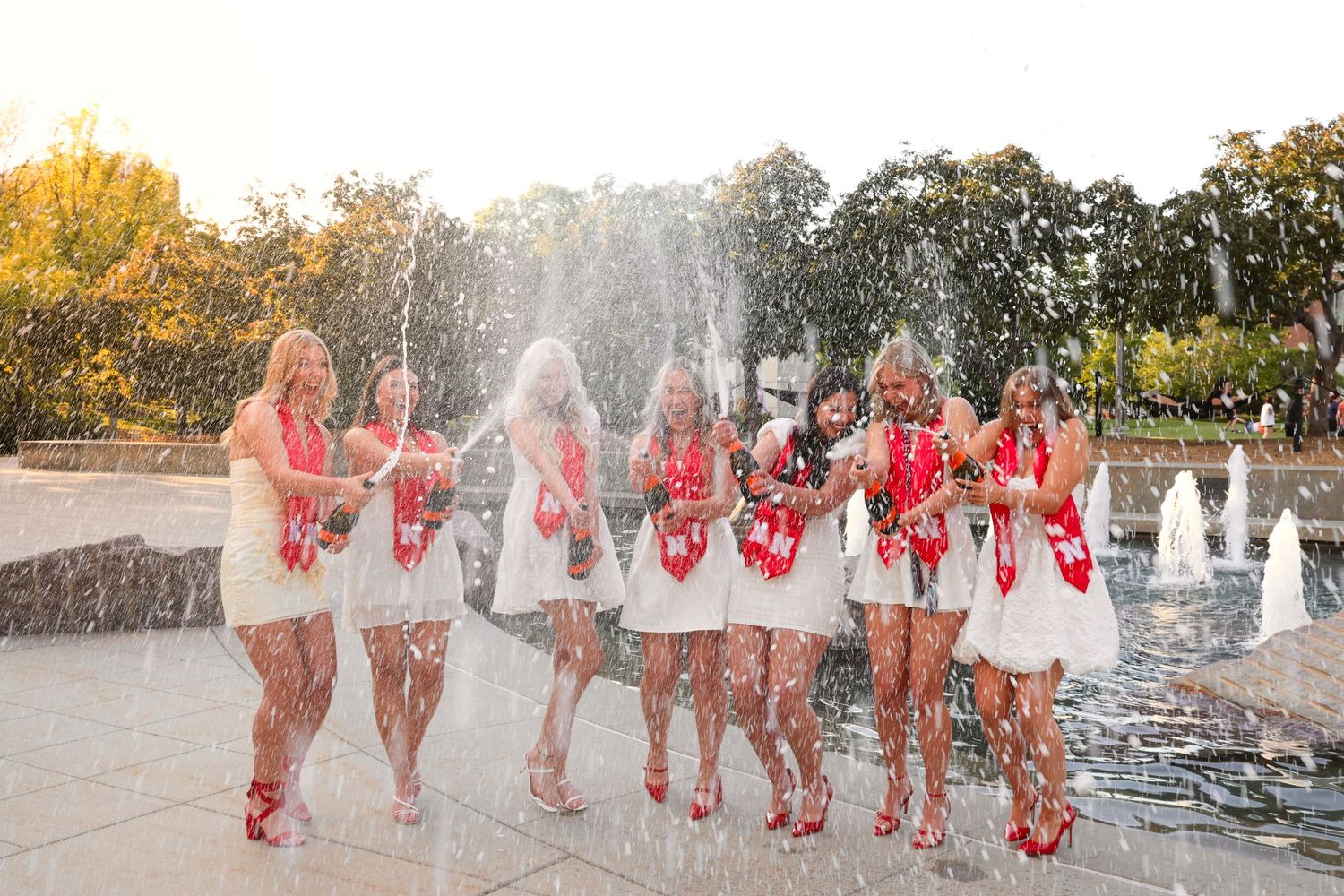 champagne pop with friends in front of fountain