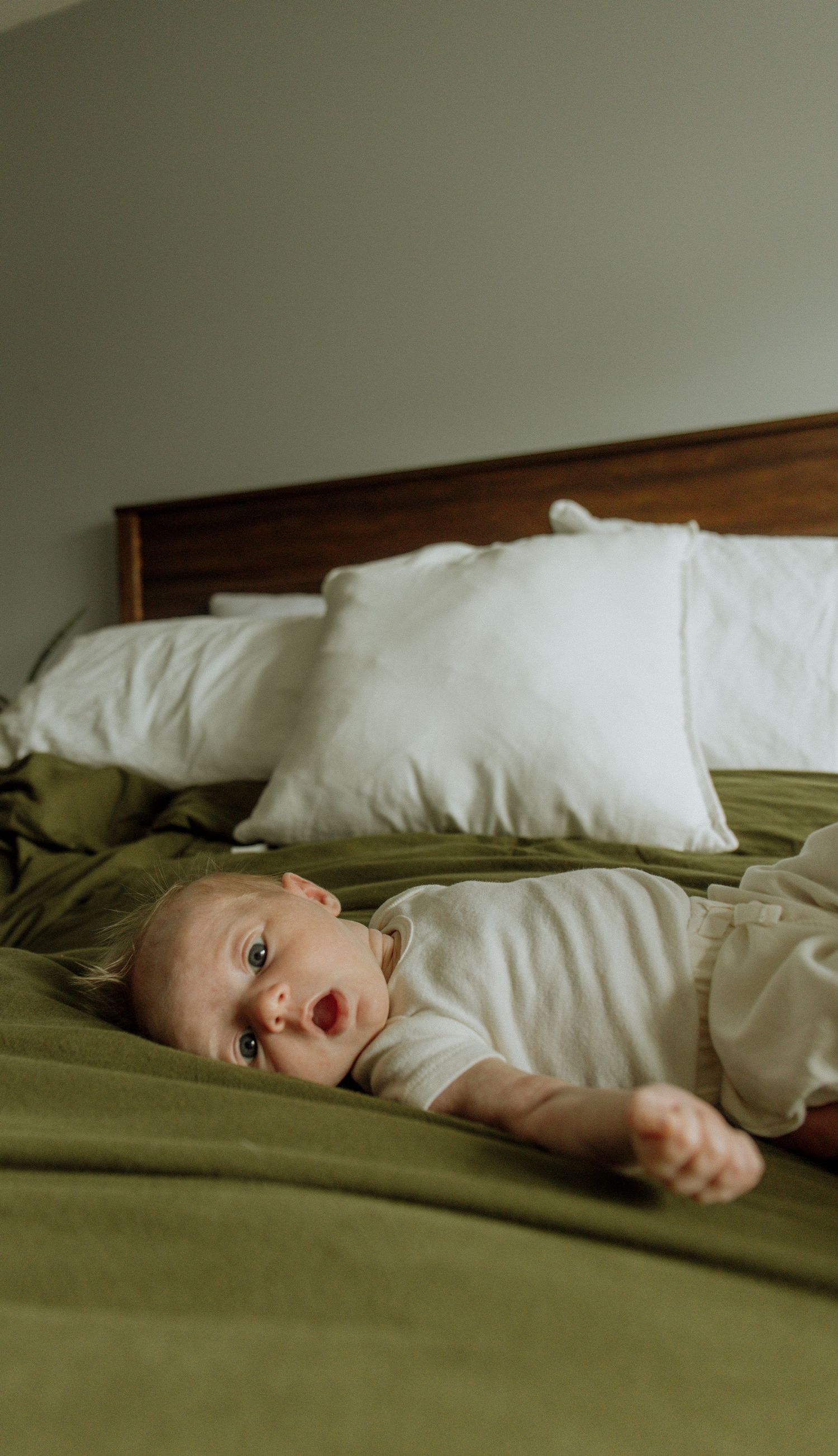 Kawartha Lakes Newborn Photography Session.
Newborn baby girl laying on bed looking at camera
