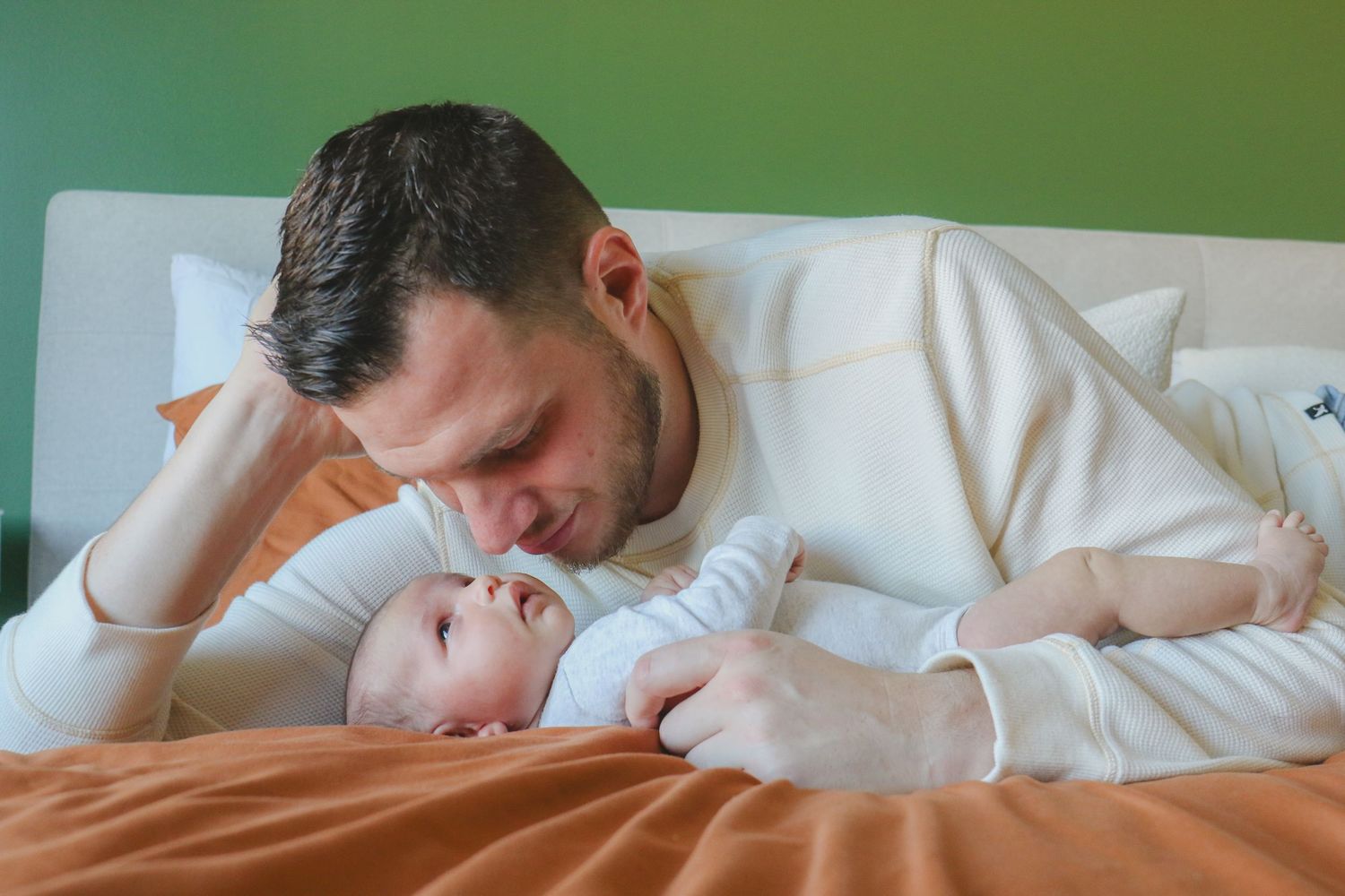 Kawartha Lakes Newborn Photography Session.
Newborn baby girl laying on bed with new dad looking at eachother