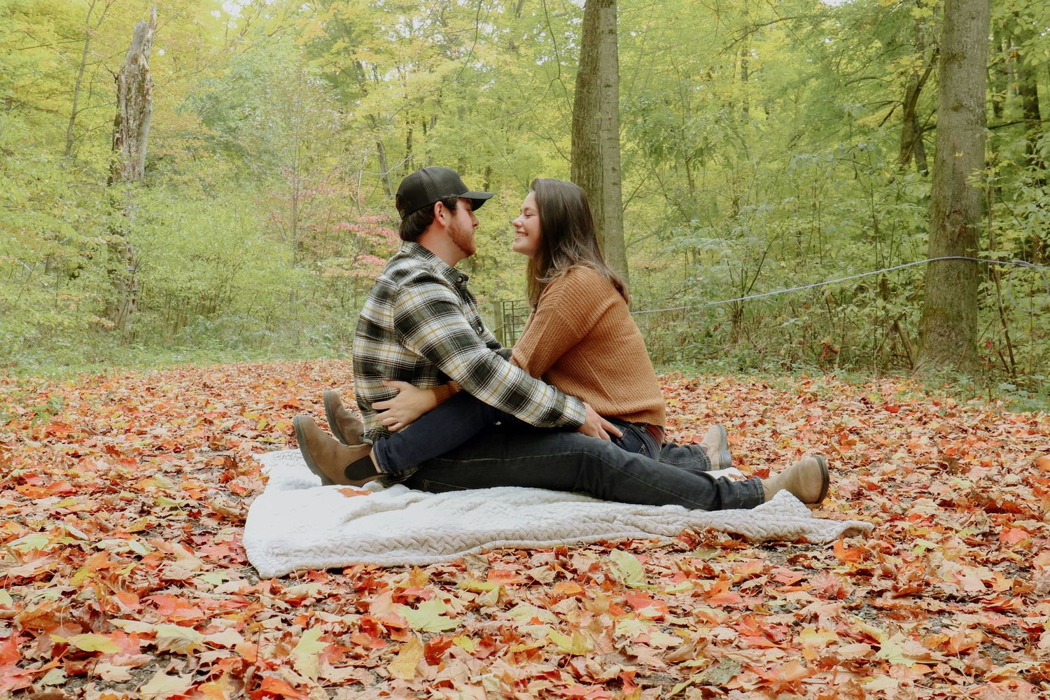 Kawartha Lakes Couple Photography Session.
Boyfriend and girlfriend sitting on a blanket together in an open field in the fall