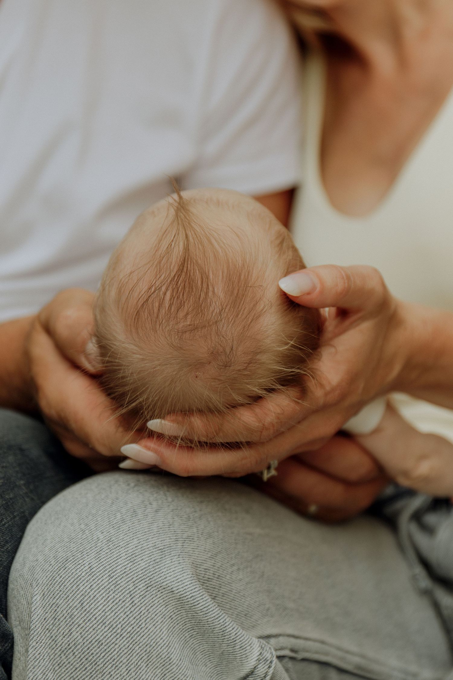 Kawartha Lakes Newborn Photography Session.
Close up detail shot of mom and dad holding newborn baby girls head in hands