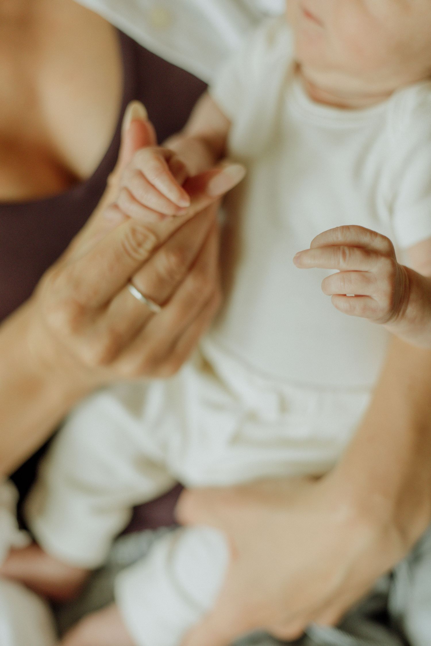 Kawartha Lakes Newborn Photography Session.
Close up detail photo of newborn baby girl holding moms finger