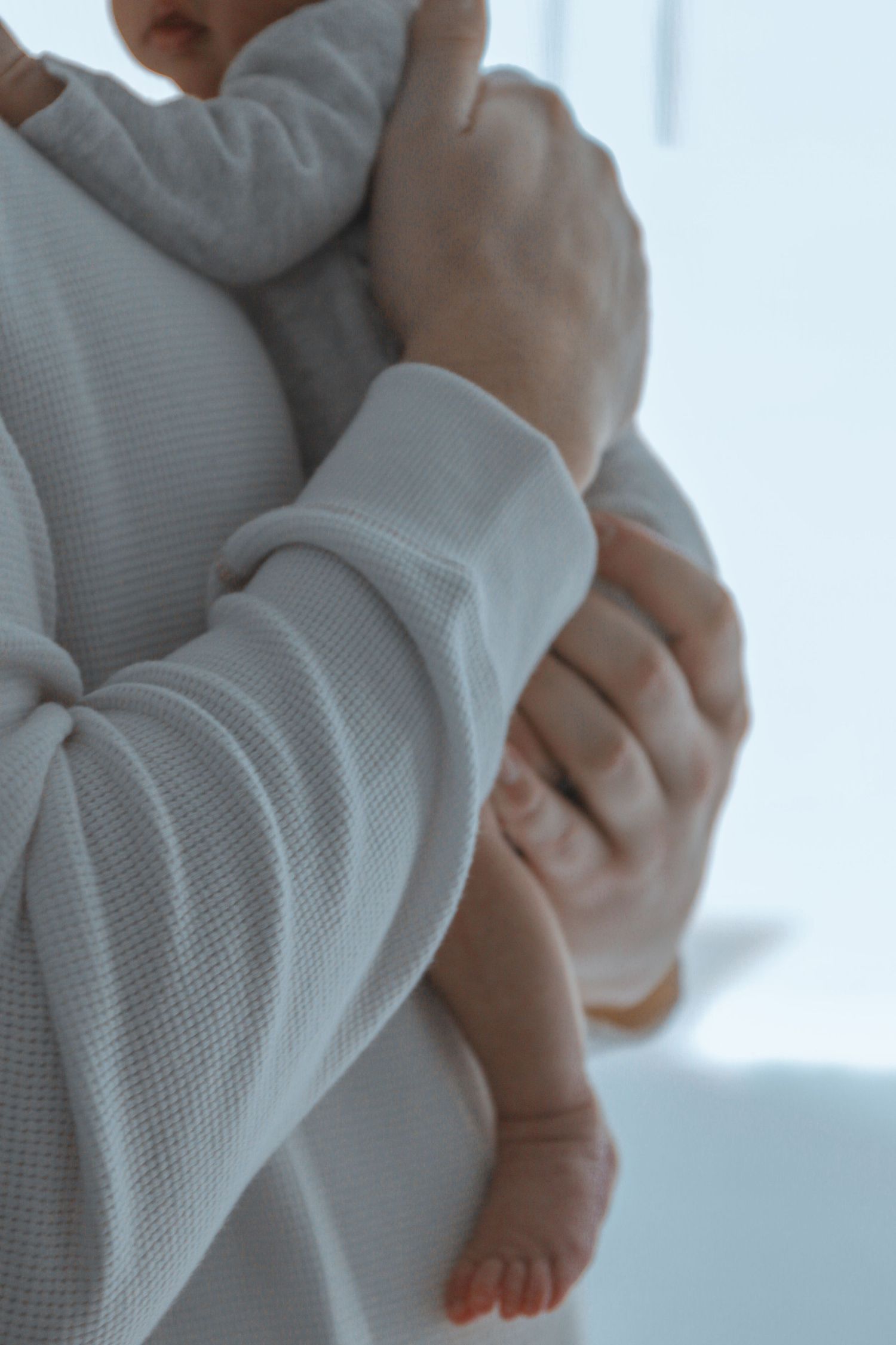 Kawartha Lakes Newborn Photography Session.
Close up detail photo of dad holding baby girl newborn daughter