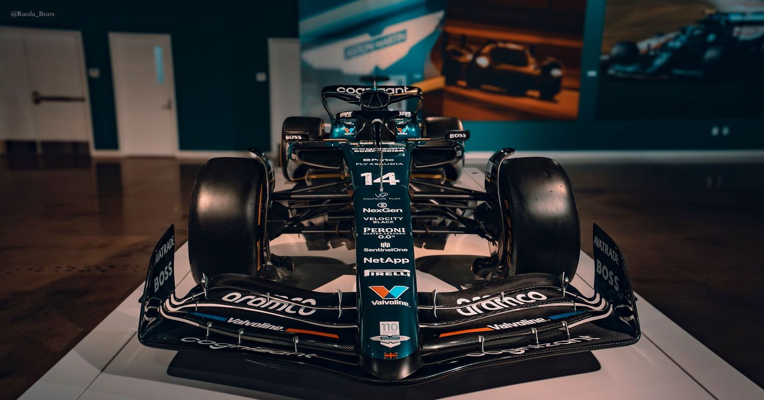 Aston Martin AMR F1 car number 14 on display at an indoor motorsport exhibition.