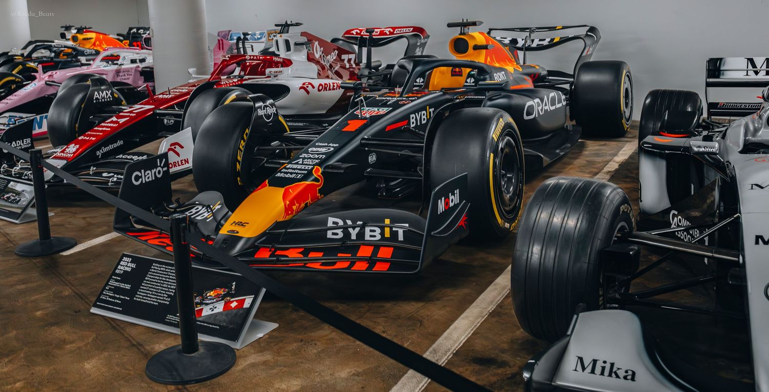 Red Bull Racing Formula 1 car with Bybit sponsorship displayed in a motorsport museum.