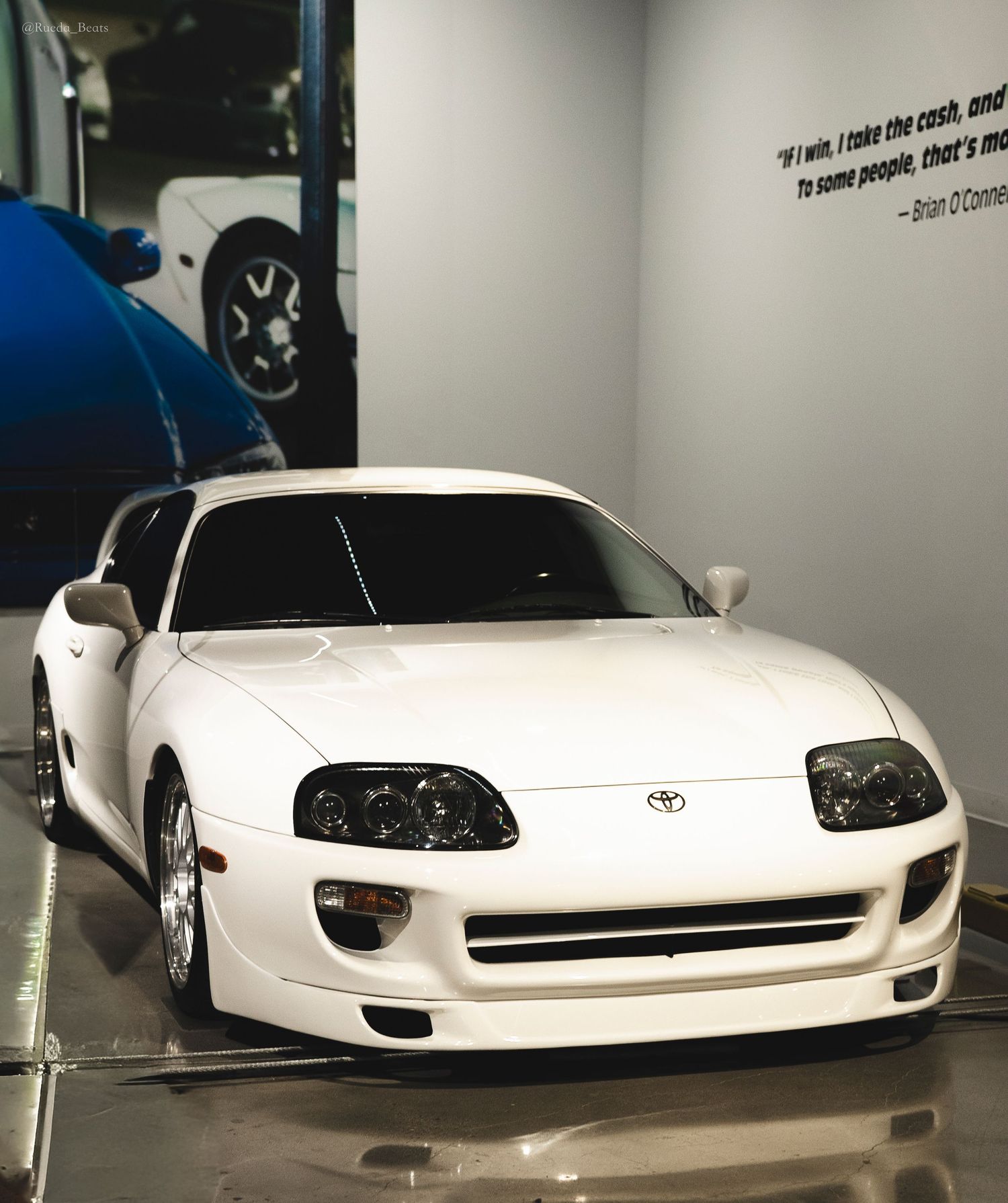 White Toyota Supra MK4 on display at Fast and Furious museum with Brian O'Connor movie quote.