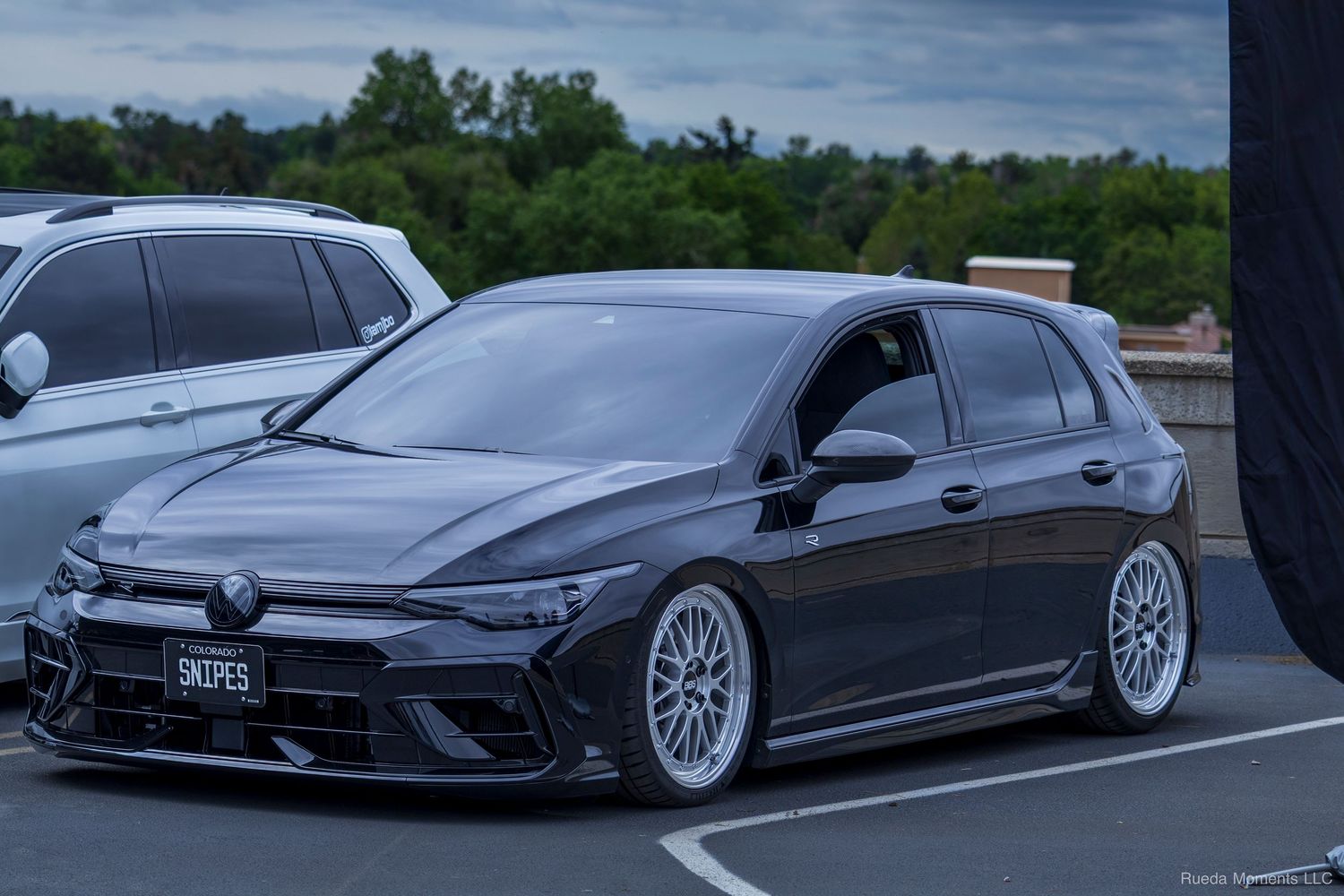 Slammed dark gray VW Golf Mk8 on BBS wheels at a car meet.