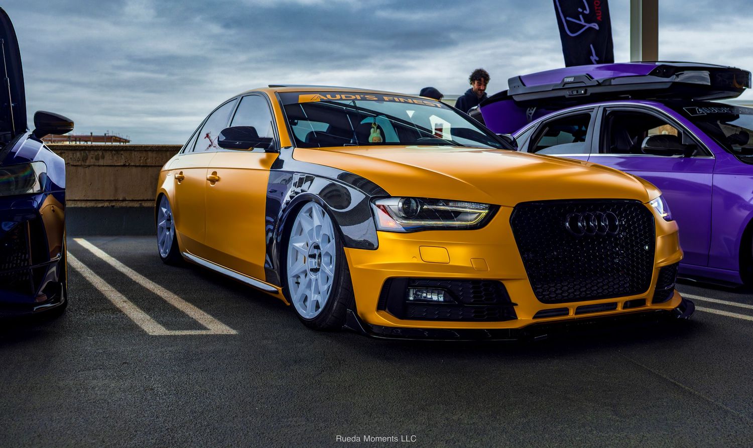 Gold slammed Audi A4 on white wheels at outdoor car meet.