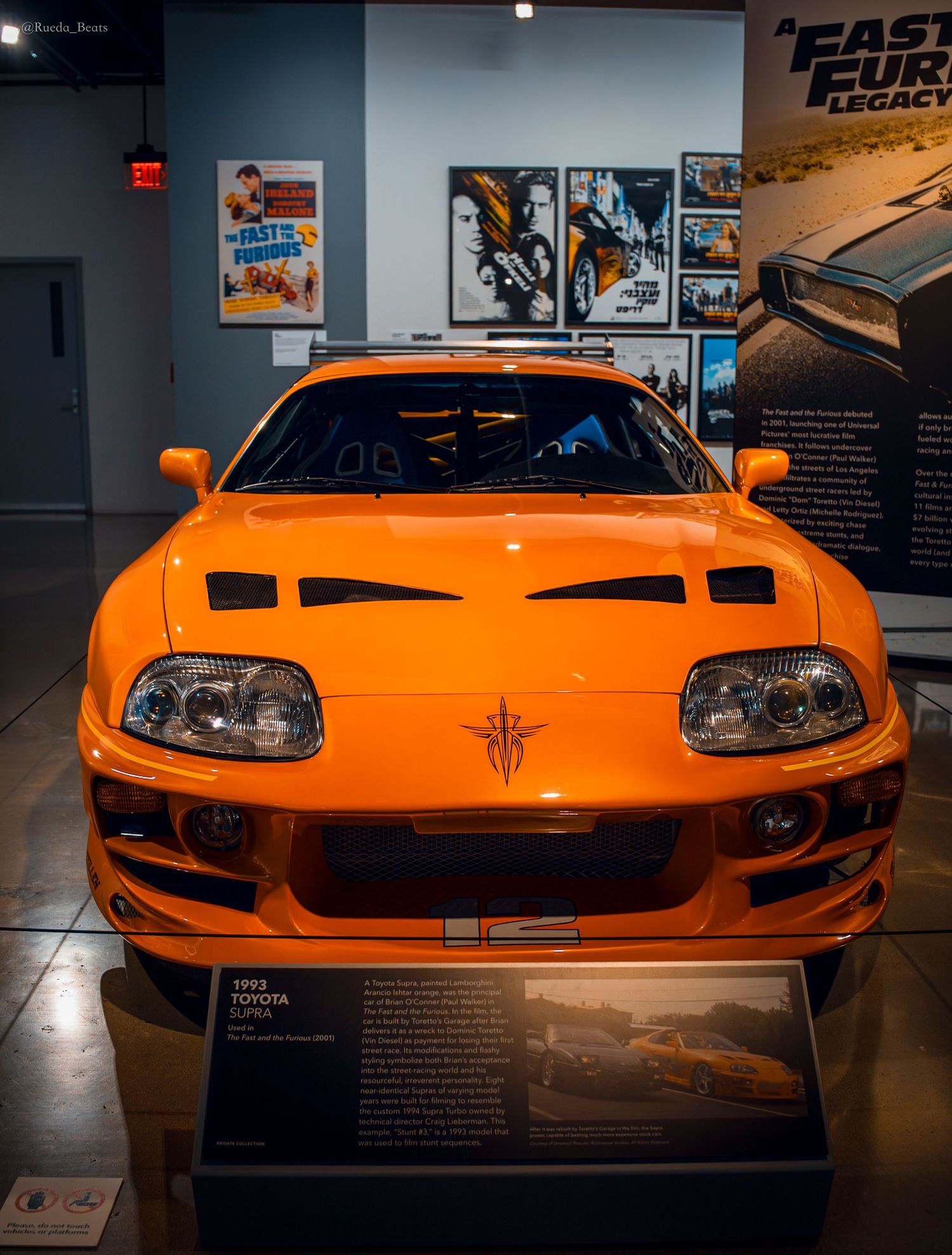 Front view of orange 1993 Toyota Supra from Fast and Furious franchise at museum display.