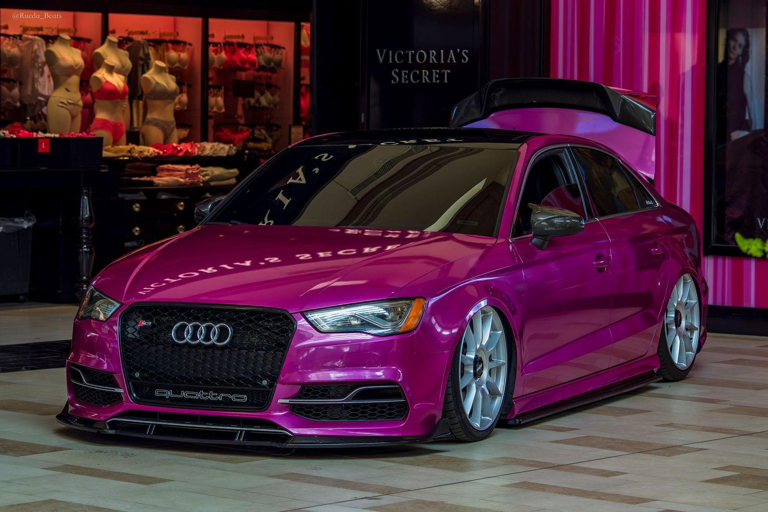 Stunning pink Audi S3 Quattro lowered show car parked in front of Victoria's Secret store.