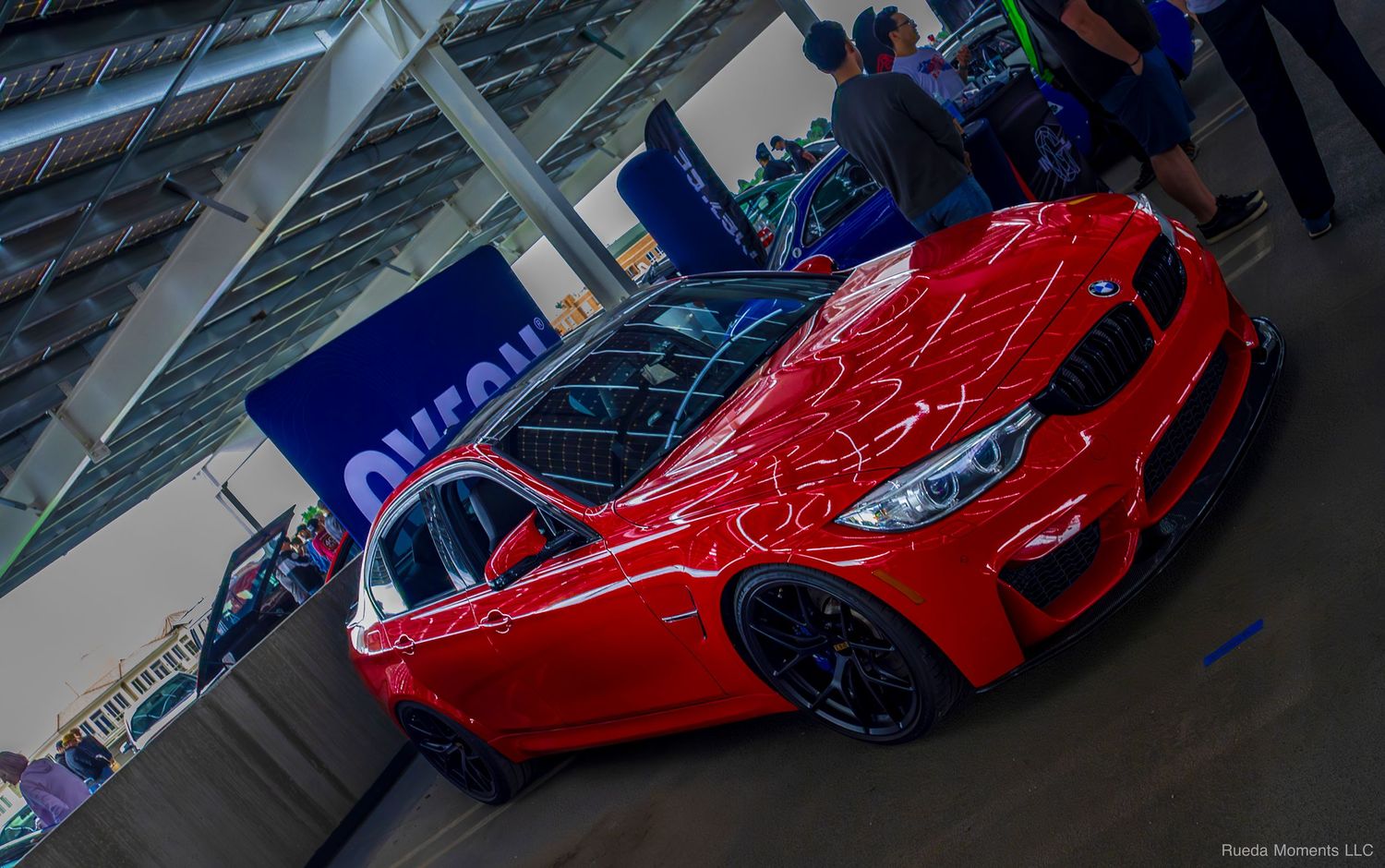 Stunning red BMW M series sports car on display at an indoor automotive show.