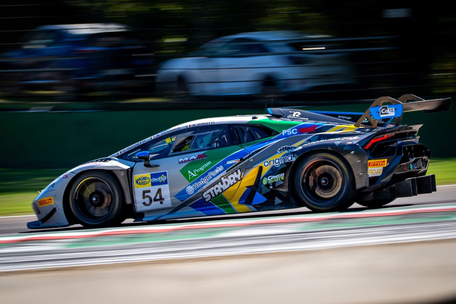 GT3 race car speeding through Imola, captured with a dynamic panning effect.