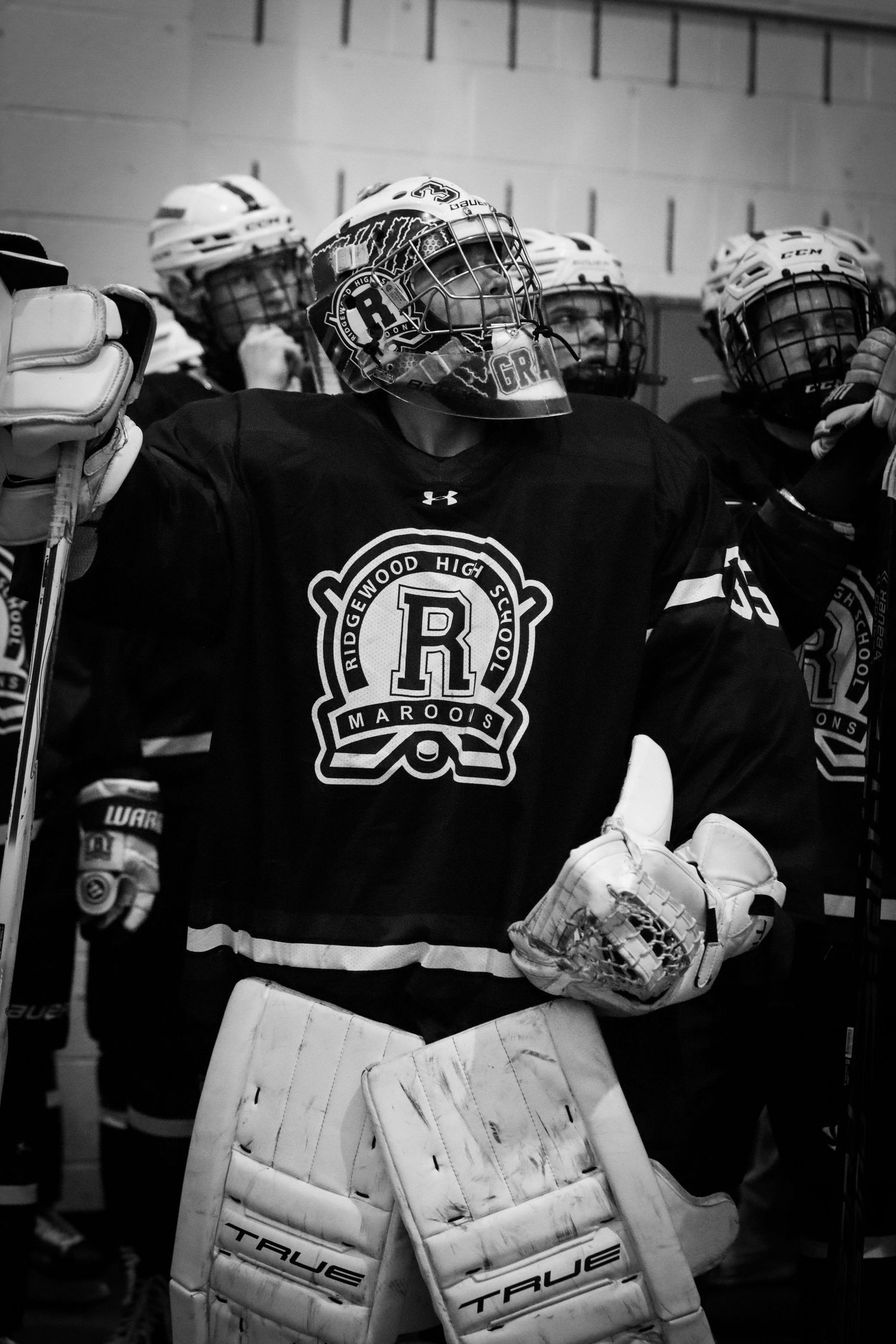 Black and white portrait of a Ridgewood High School Maroons hockey goalie in full gear.