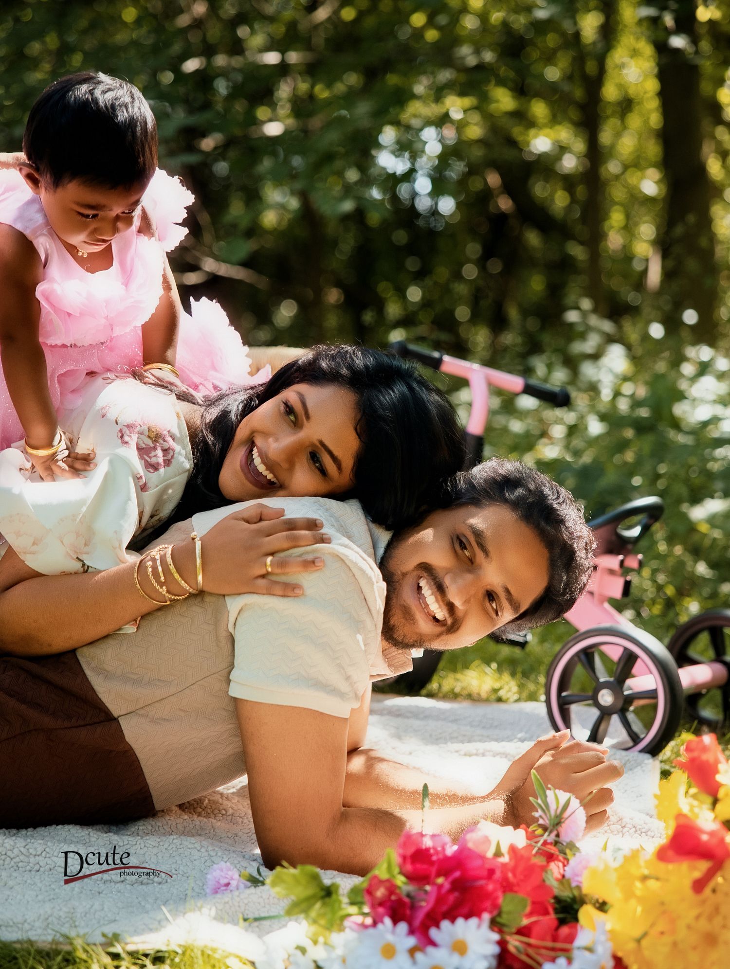 A joyful family photo with parents smiling. Family portrait at a Toronto park during an outdoor photography session