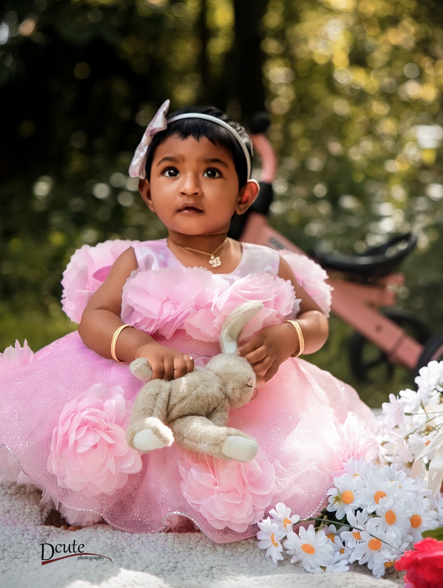Child photographer in North York, featuring a young girl smiling naturally while wearing a pink tulle dress
