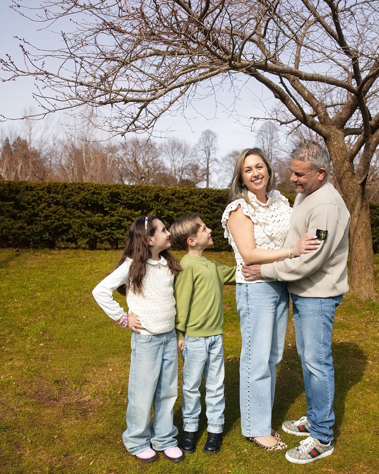 Family photography in Downtown Toronto captures parents embracing and children looking up smiling.