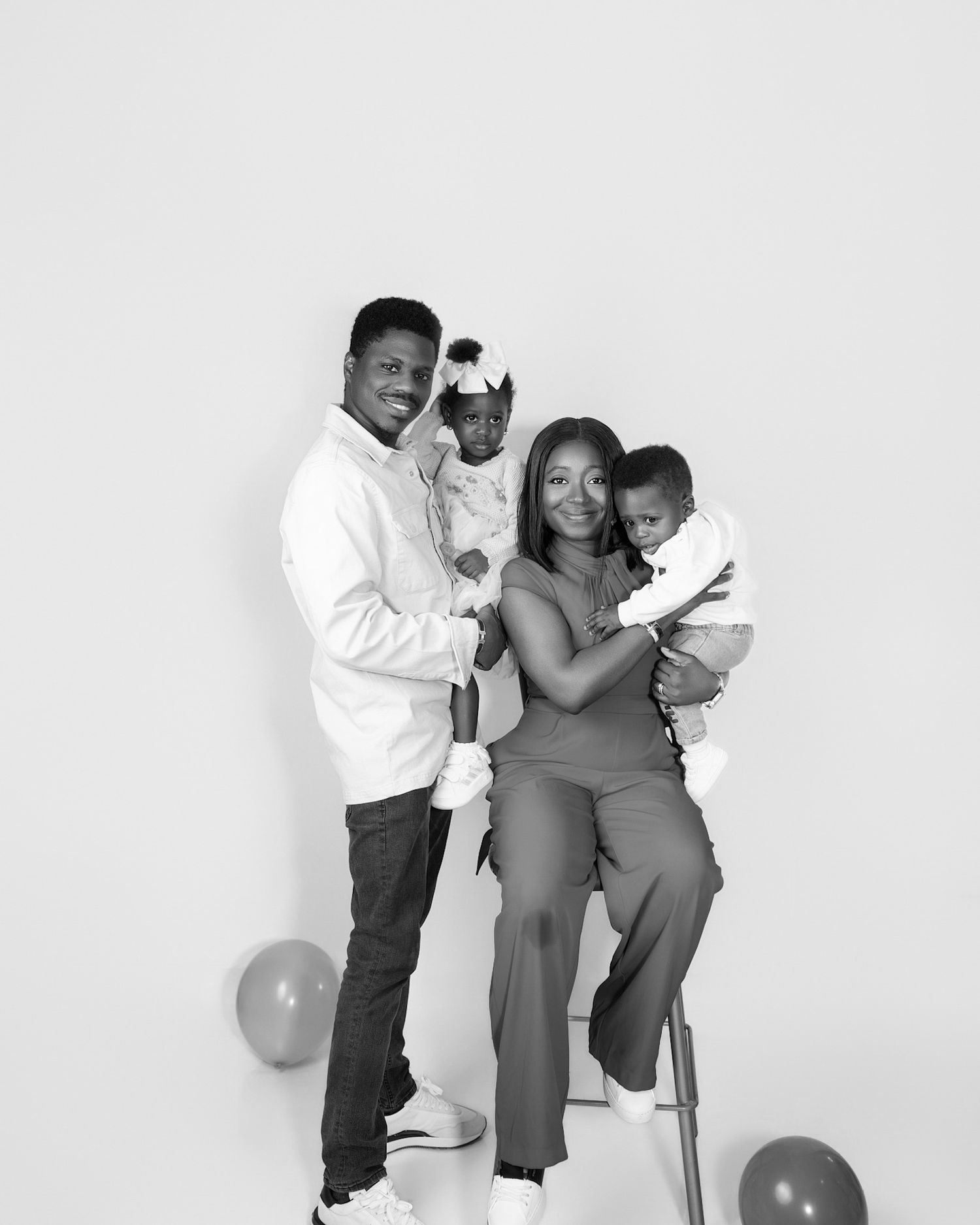 Family photographer in Toronto, family smiling together in a timeless studio portrait