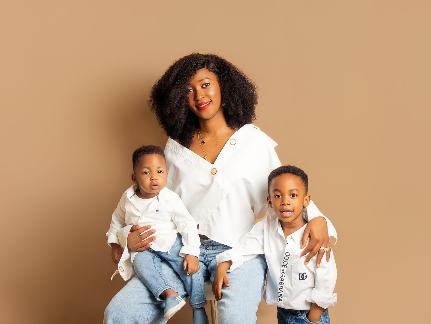 Black mother with natural hair poses with her two young sons in Downtown Toronto family photography