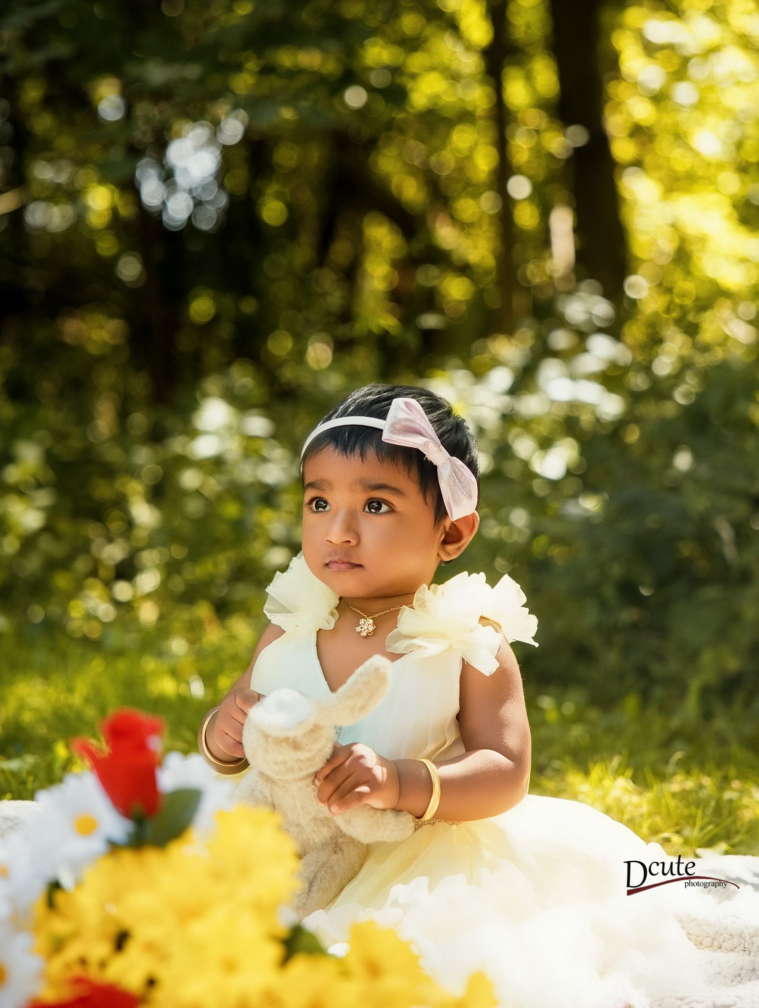 Children’s photographer North York, Toronto, featuring two children celebrating a birthday surrounded by balloons & flowers in sunny garden.