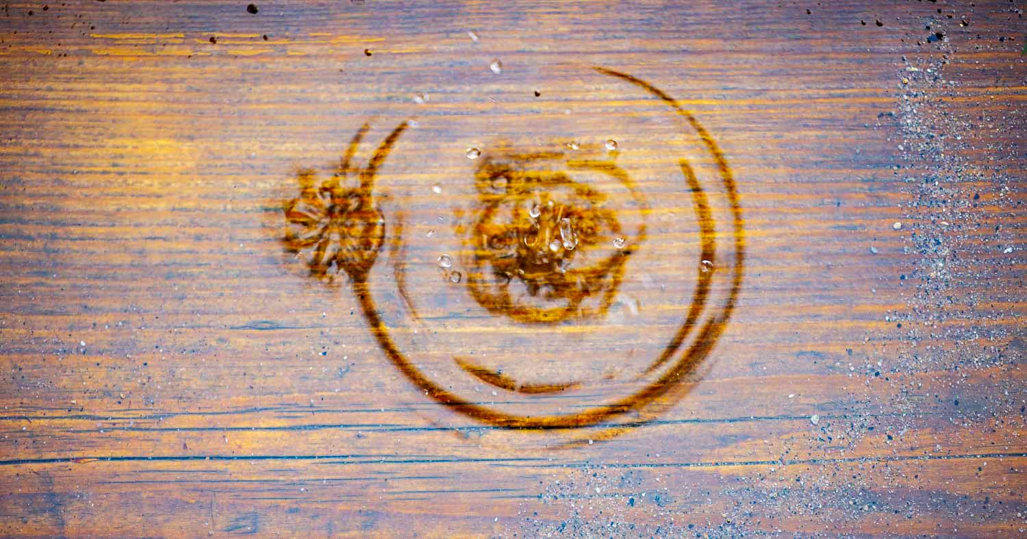 Arrival
Goutte d'eau, 
Québec, Canada
Close-up of circular water stains and sticky residue marks on a weathered wooden surface.