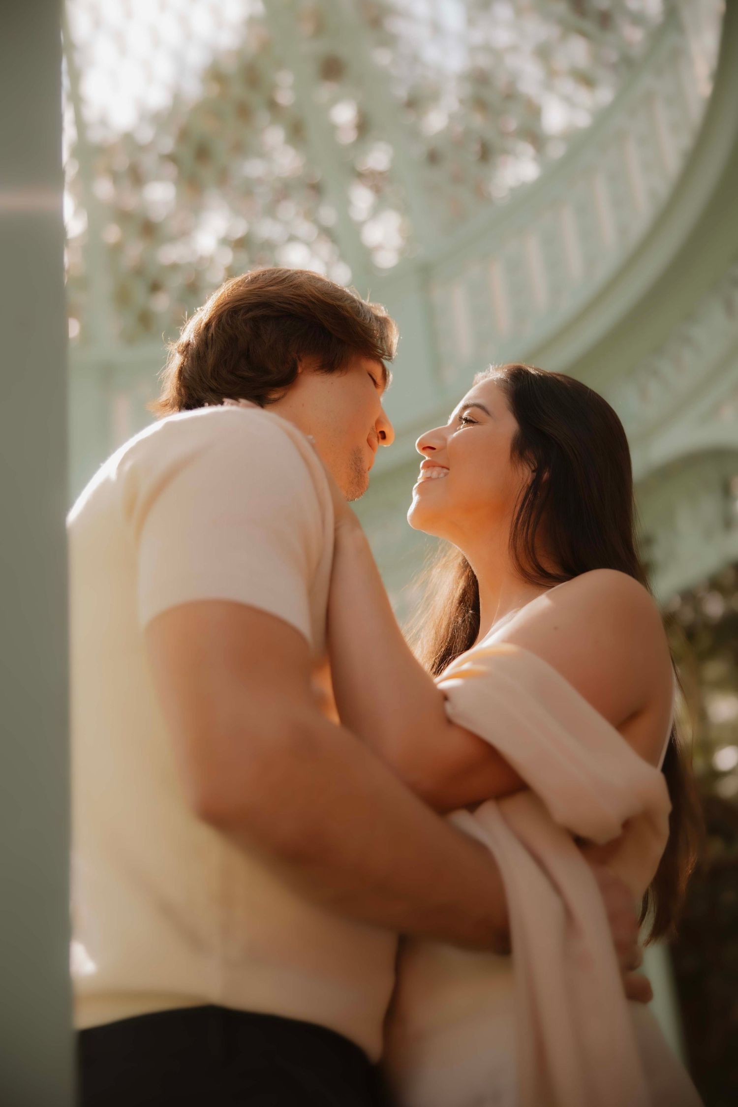An intimate moment captured between a couple in soft natural lighting.