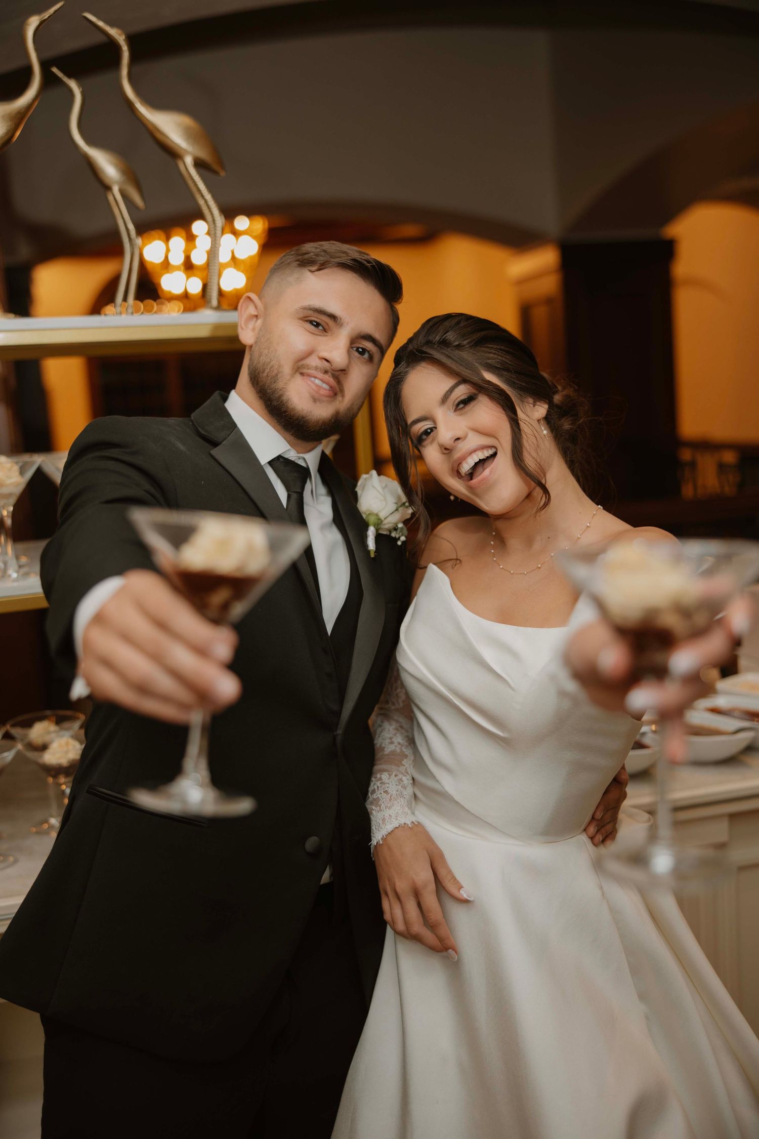 Newlyweds raise their wine glasses in a celebratory toast at their reception.