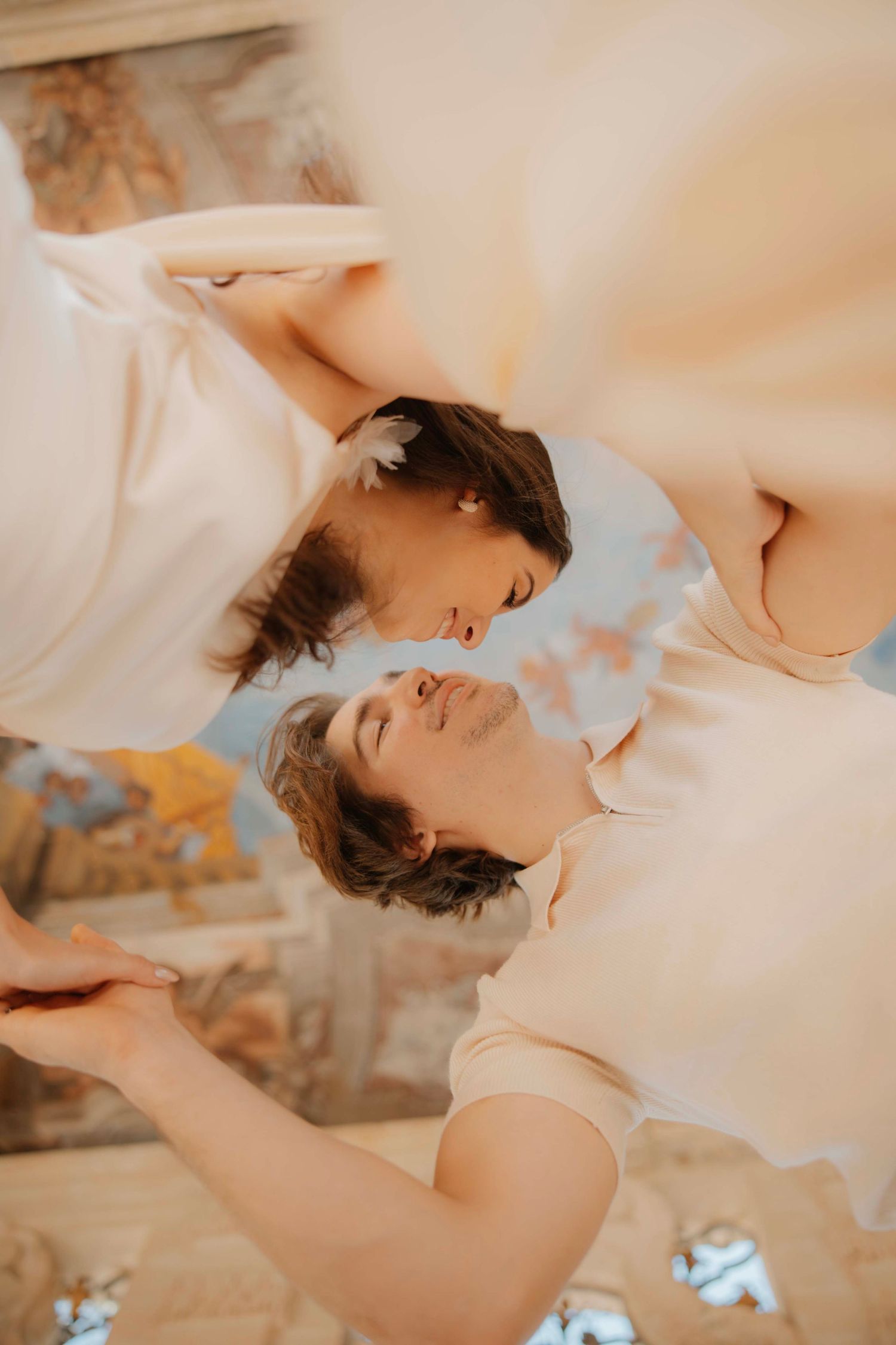 A romantic couple's maternity photoshoot with soft natural lighting and warm tones.